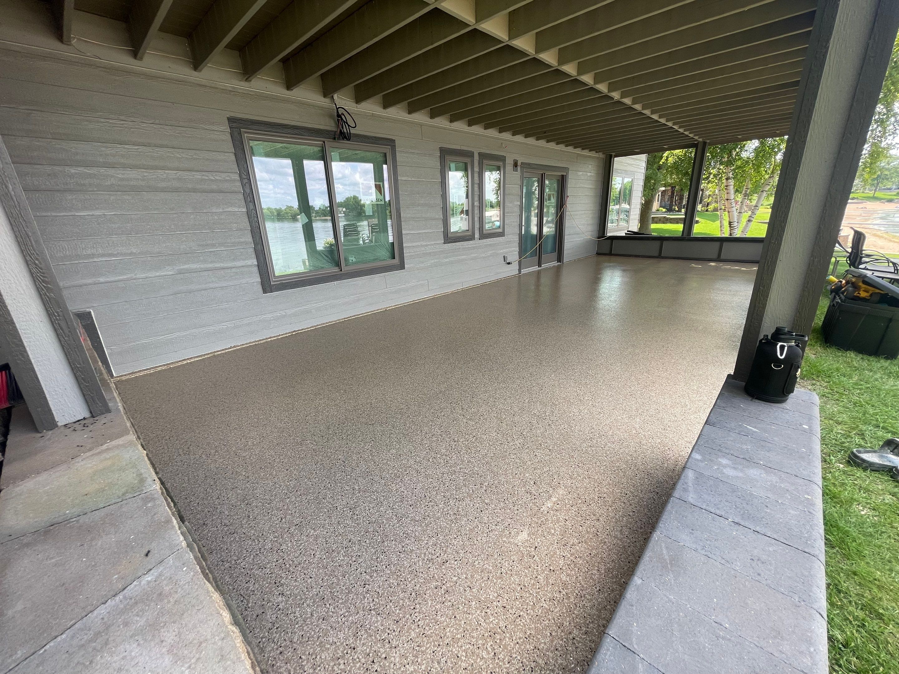 Lakefront Screened Patio Concrete Coating Installation in Wentworth by Select Painting, Coatings & Garage Cabinets