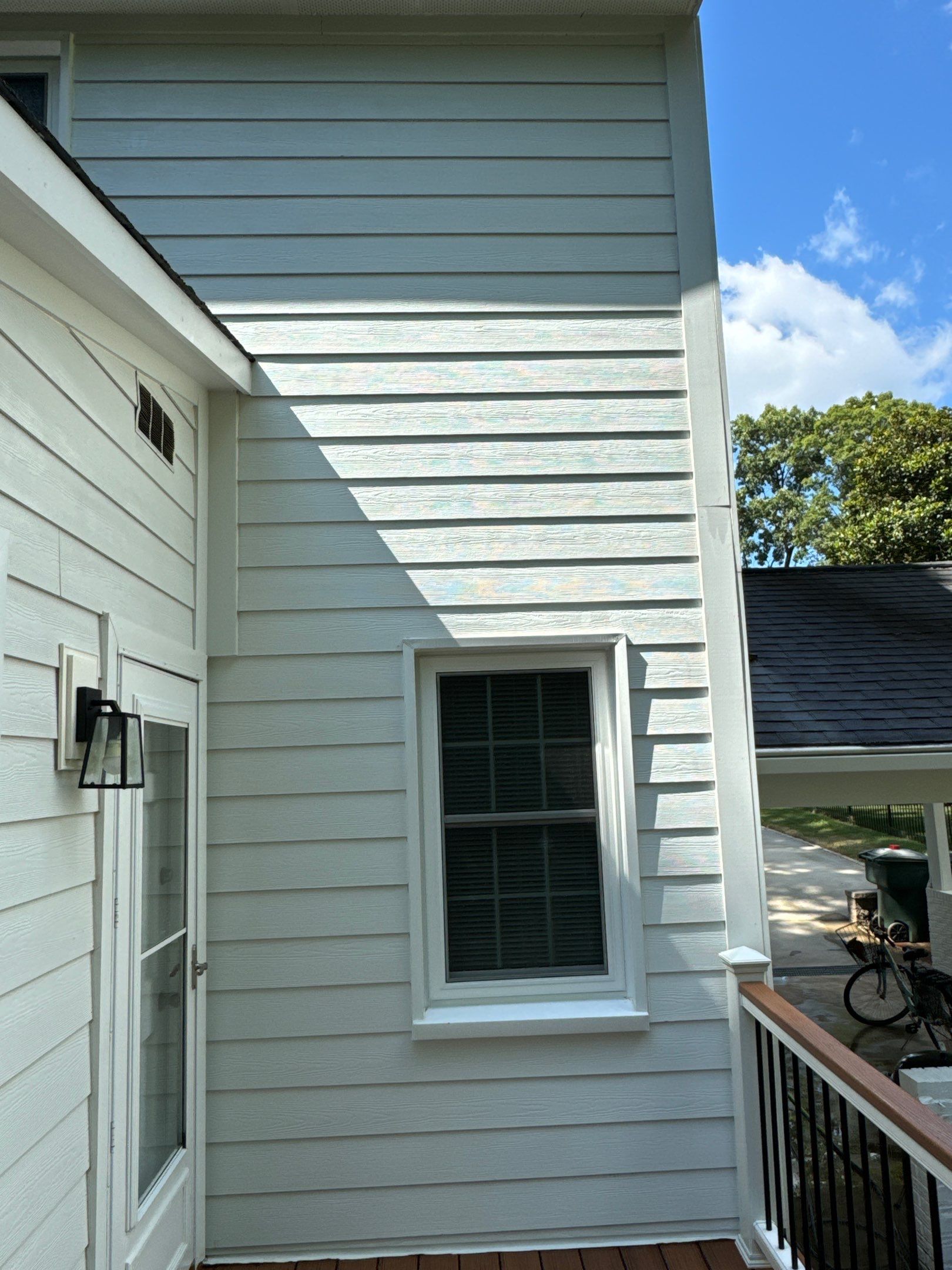 cleaning the exterior siding of a house with pressure washing services ensuring the surfaces are free of dirt and stains