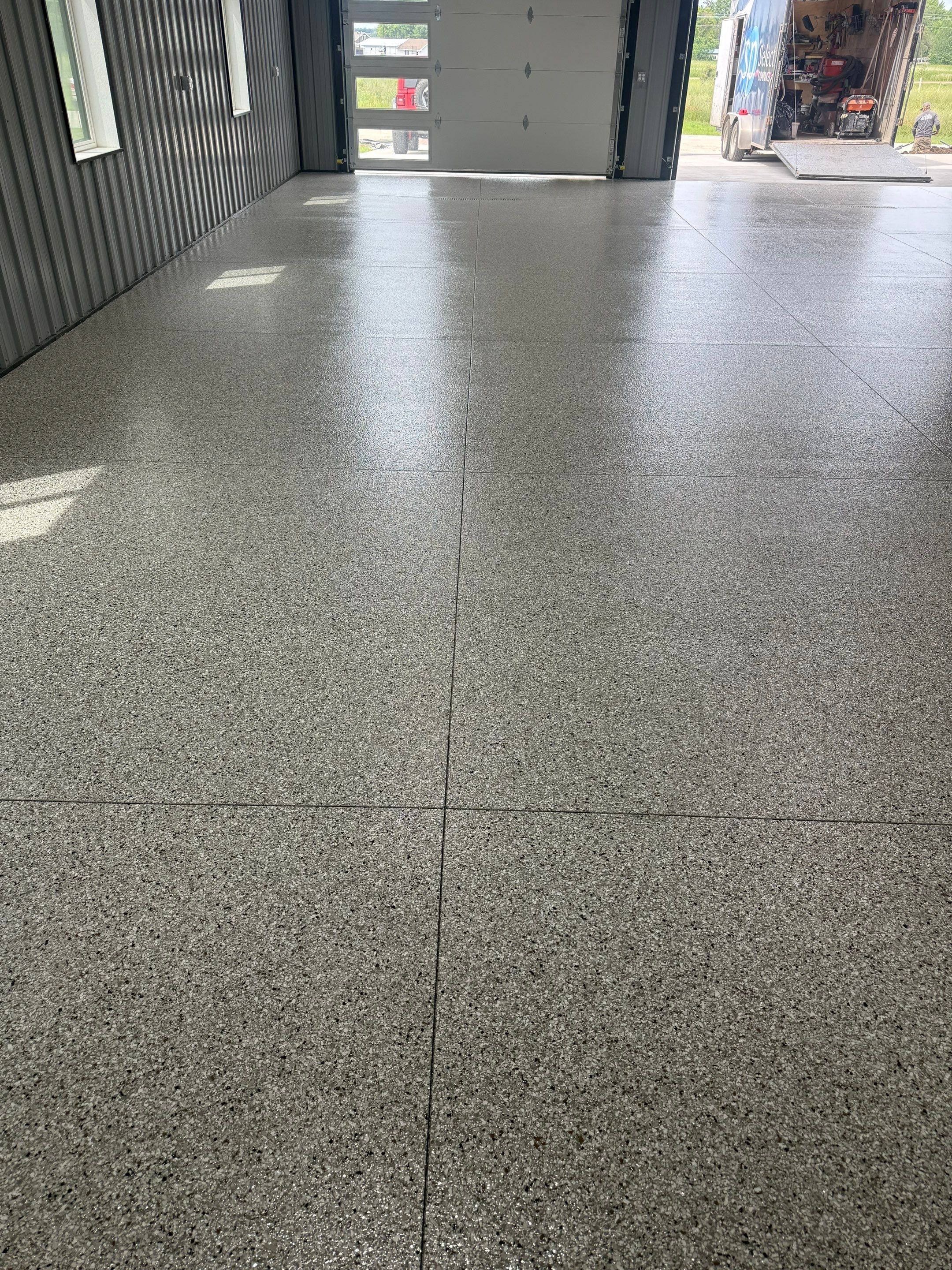 Polyaspartic Garage Floor Coating with Decorative Flake in Wentworth by Select Painting, Coatings & Garage Cabinets