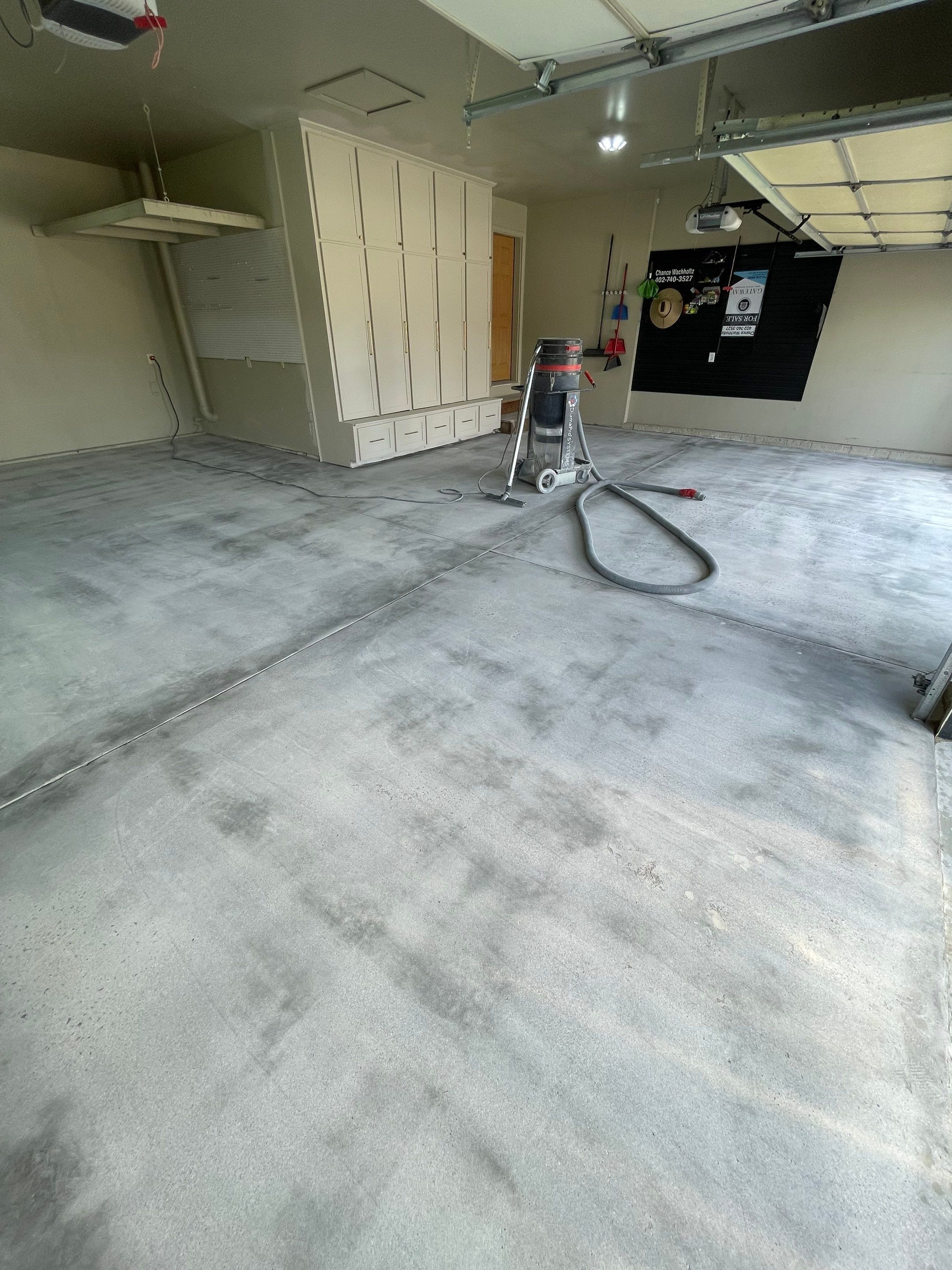 Cabin FEver Flake Garage Floor Coating Installation in Sioux Falls by Select Painting, Coatings & Garage Cabinets