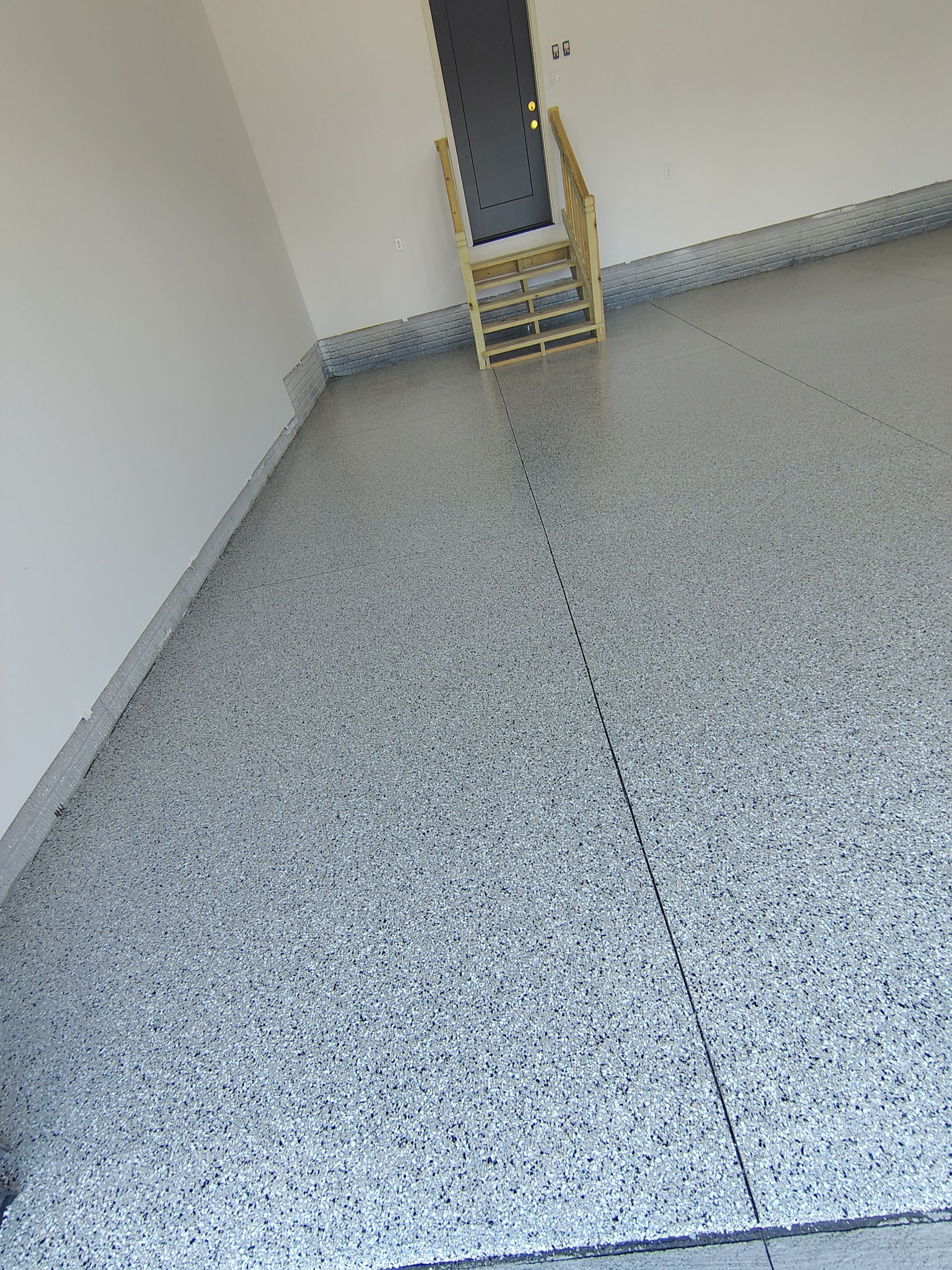 Cabin Fever Decorative Flake Garage Floor Coating in Sioux Falls by Select Painting, Coatings & Garage Cabinets