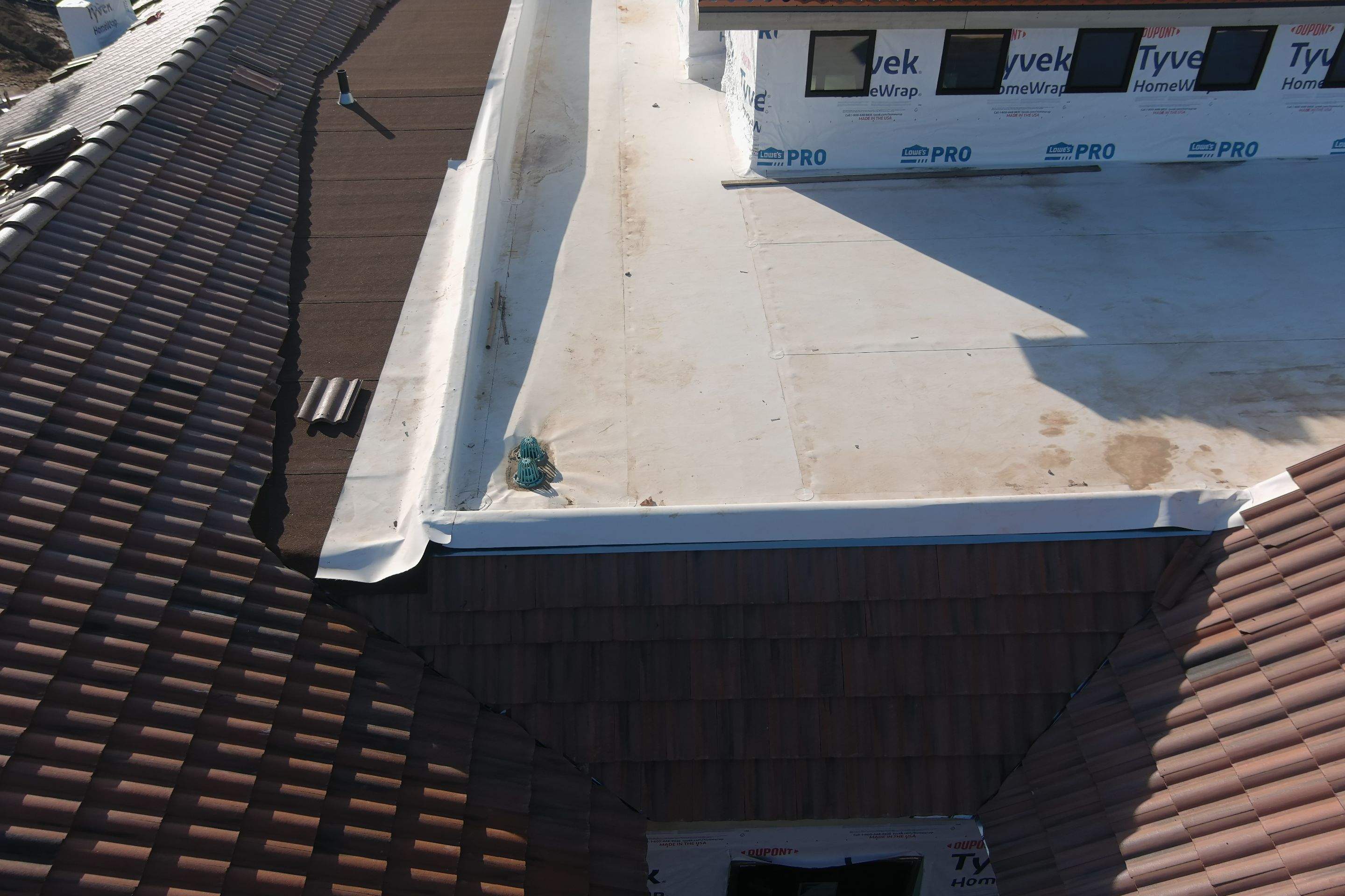 Tile, Metal, and TPO roofing project (new construction) by Straight Edge Roofing Inc