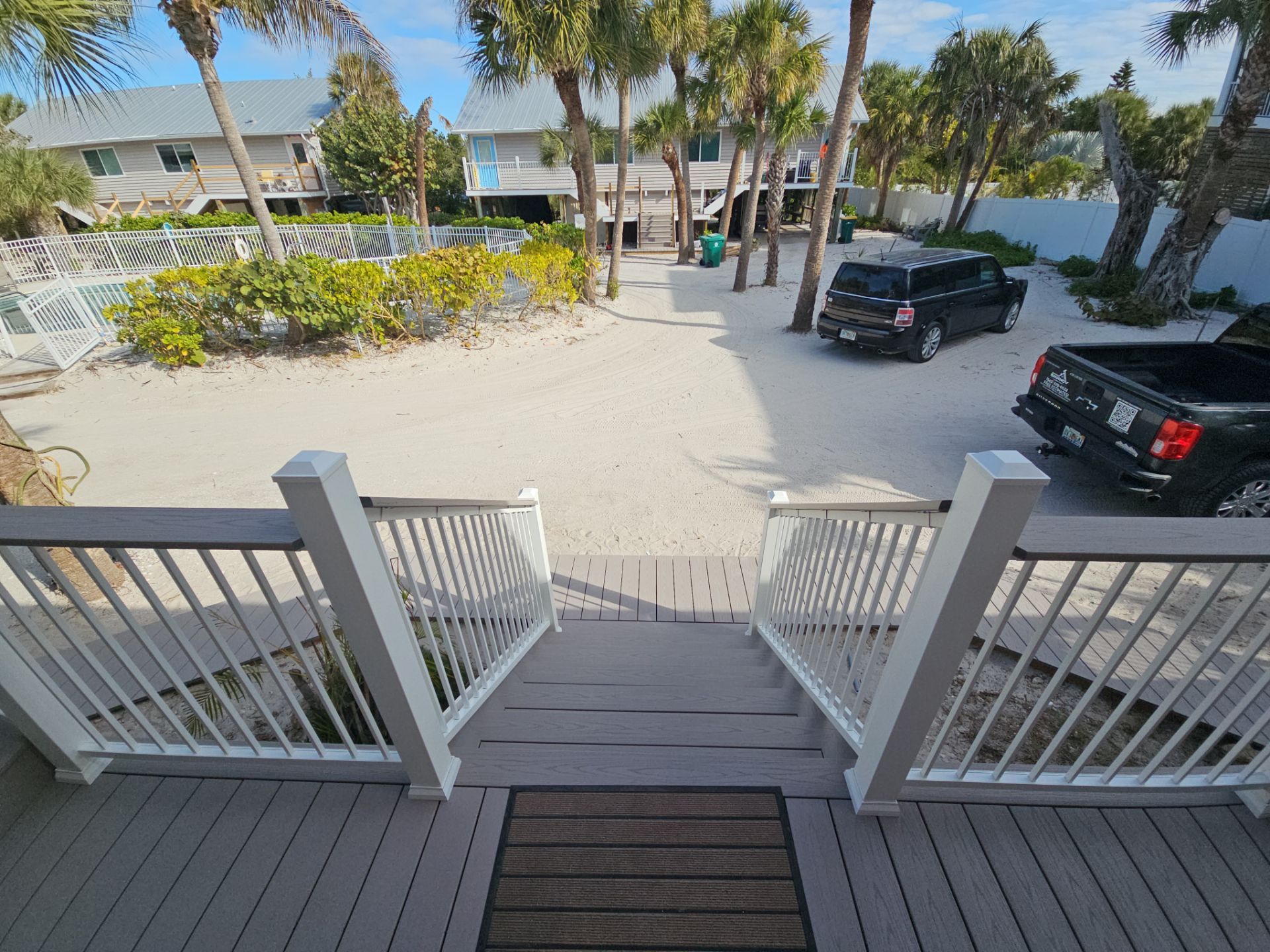 Elevated Home Deck Reconstruction With White Aluminum Railings in Placida by Smirnov Construction Inc