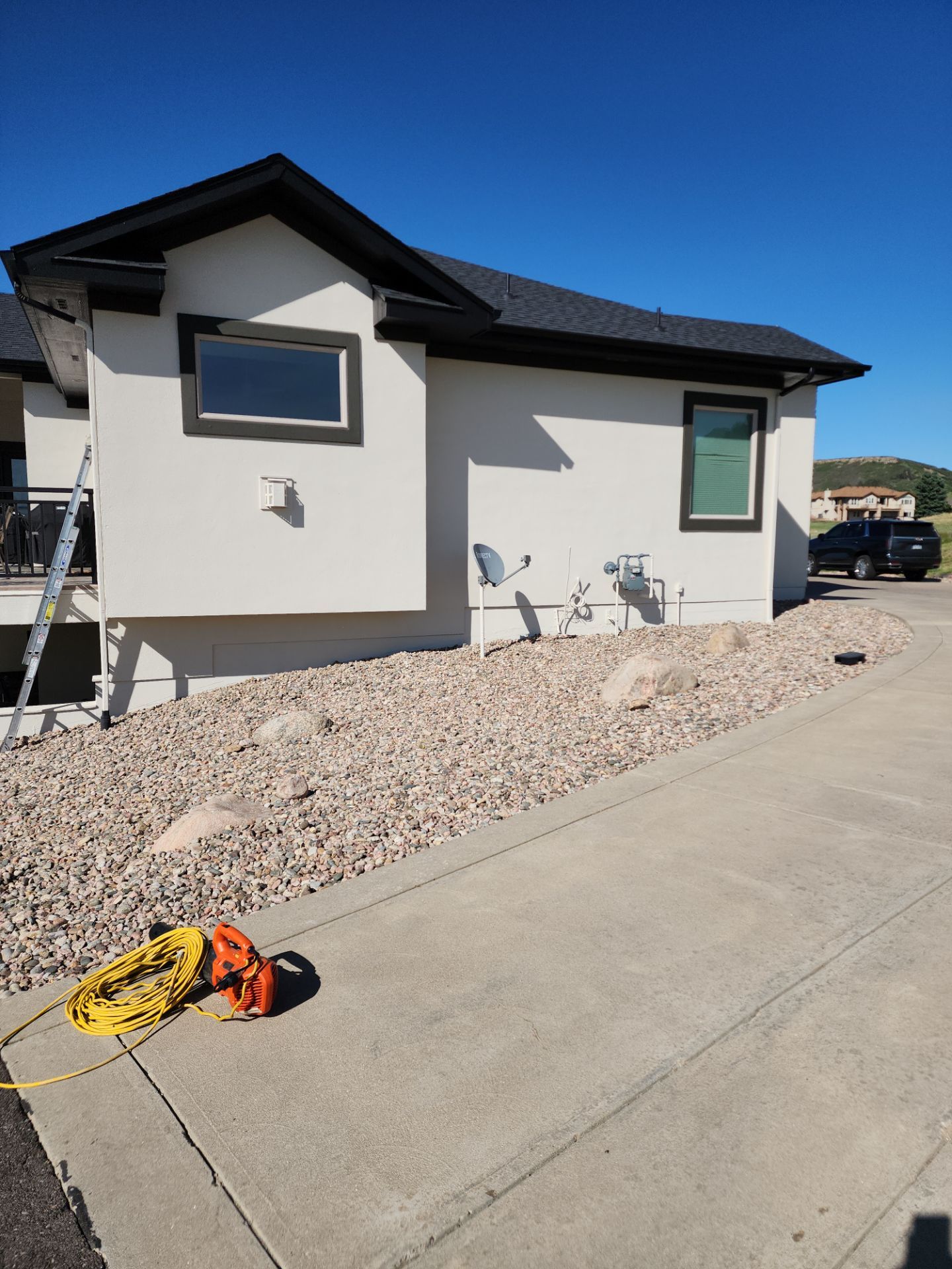 Castle Rock Elegance: White Stucco Exterior with Bold Tricorn Black by J&M Painting LLC