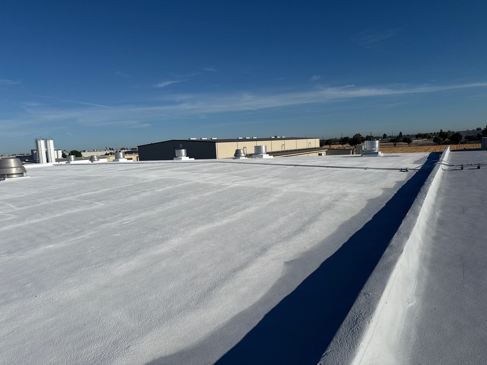 Pro Farms Spray foam roofing project by Straight Edge Roofing Inc