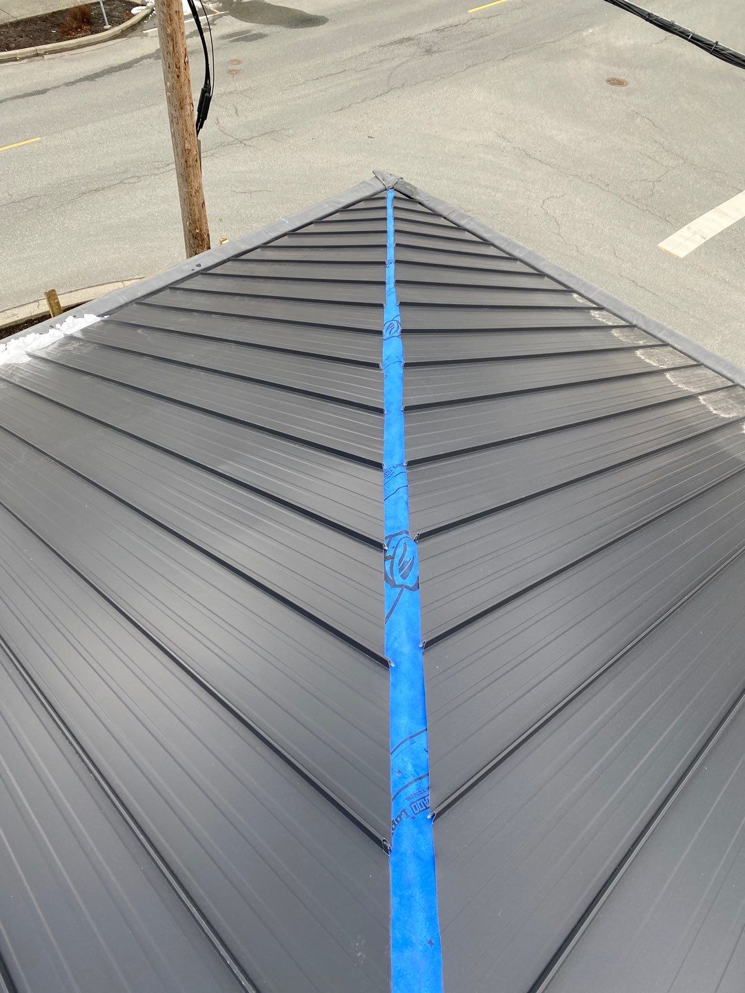 Commercial Roofing Installation using 12" Prolok metal and hidden gutters! by Top Notch Roofing Inc