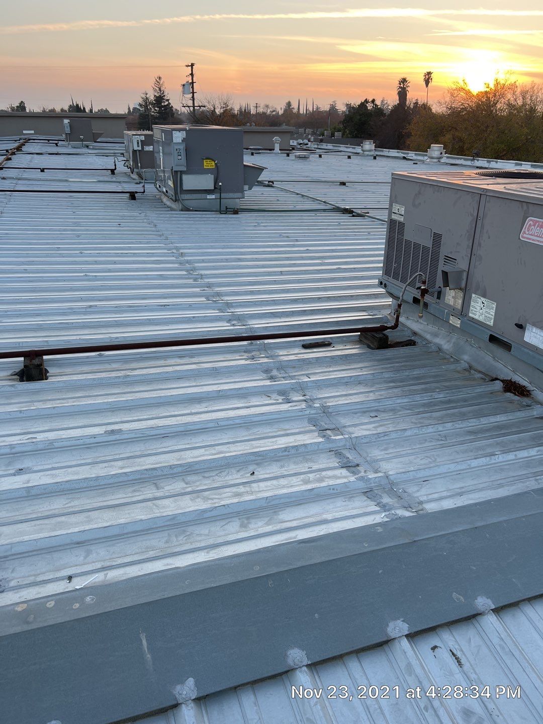 Metal roof restoration on commercial roof using Conklin Benchmark/ PUMA XL acrylic coatings over metal and foam by Straight Edge Roofing Inc