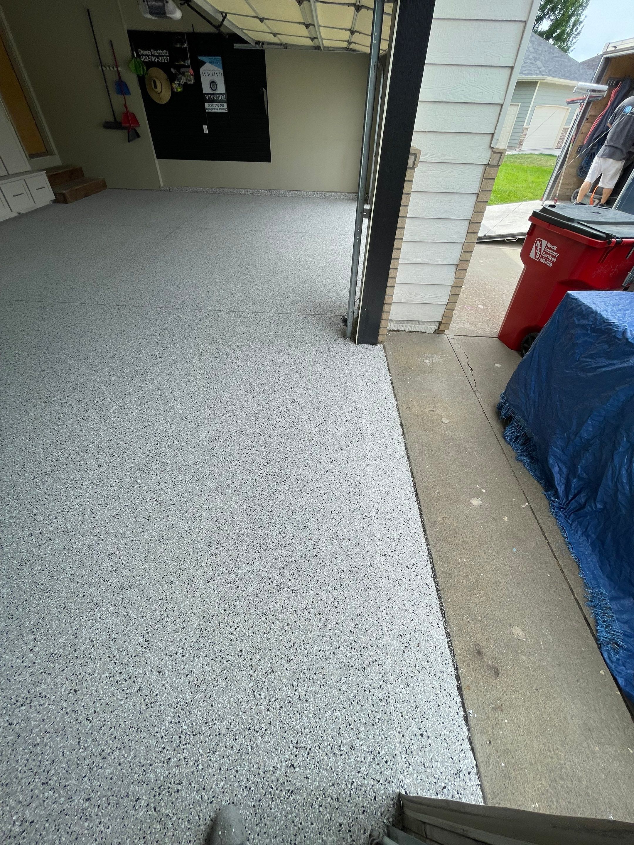 Cabin FEver Flake Garage Floor Coating Installation in Sioux Falls by Select Painting, Coatings & Garage Cabinets