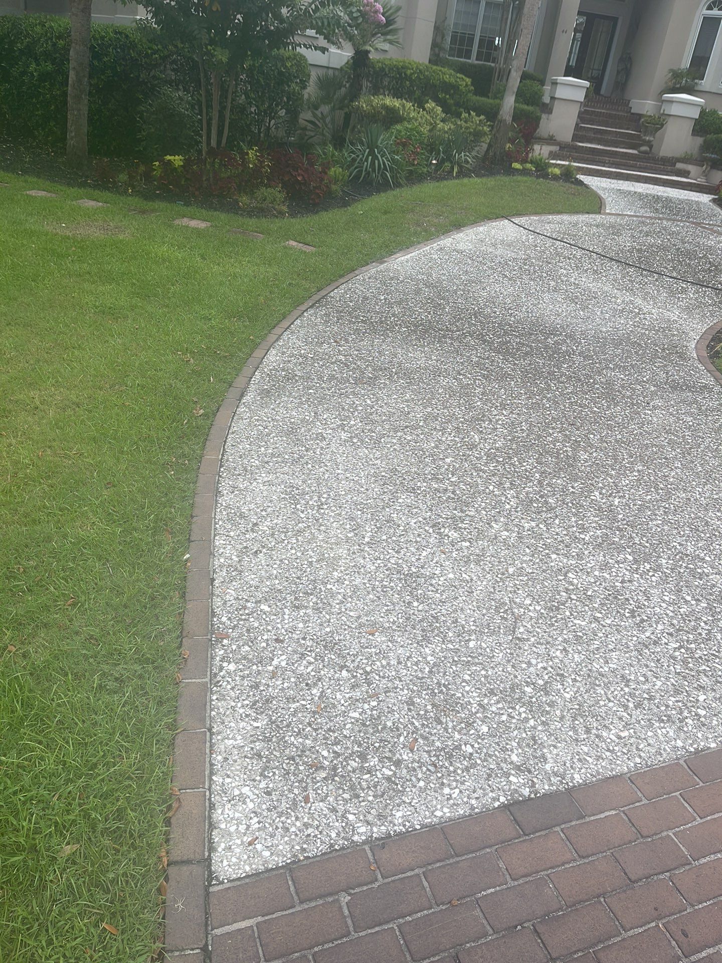 Custom Exposed Aggregate Driveway with Red Brick Borders in Hilton Head Island by Lowcountry Scapes, LLC