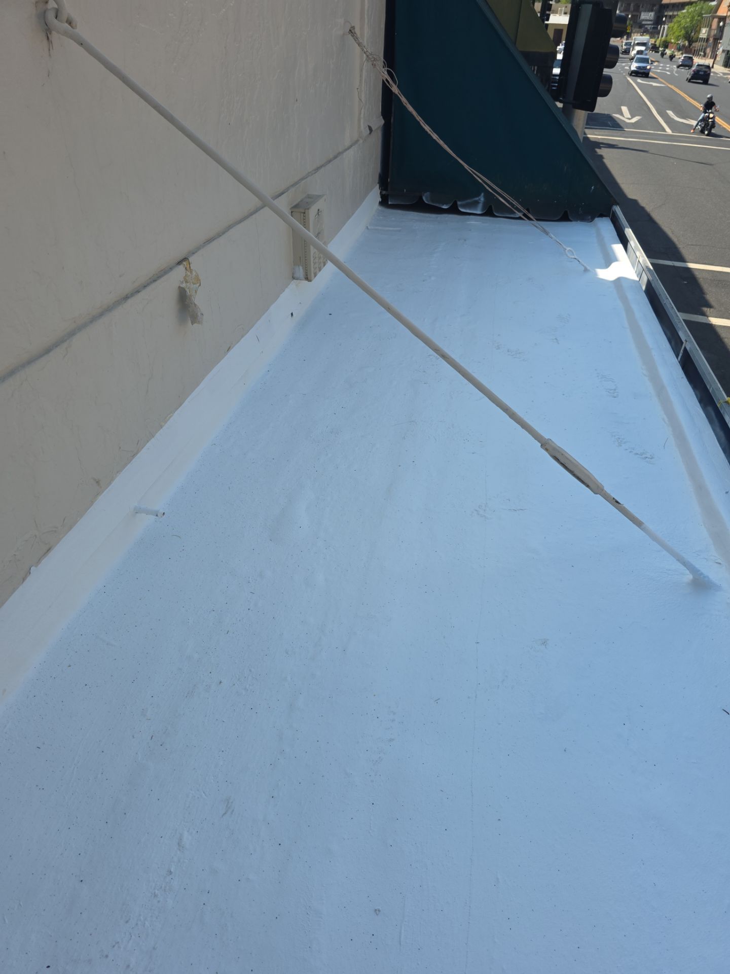Foam and coatings on commercial roof by Straight Edge Roofing Inc