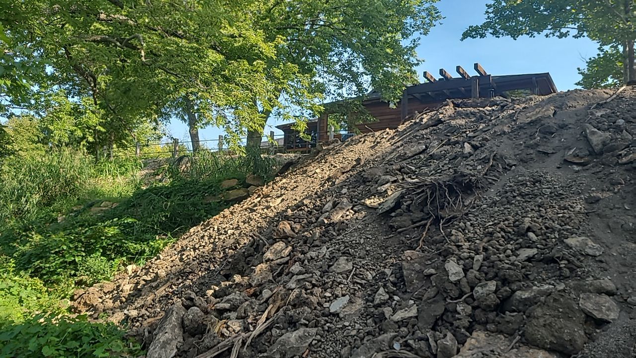 Supporting back of home with backfill at edge of steep creek by LAND ESCAPES LLC