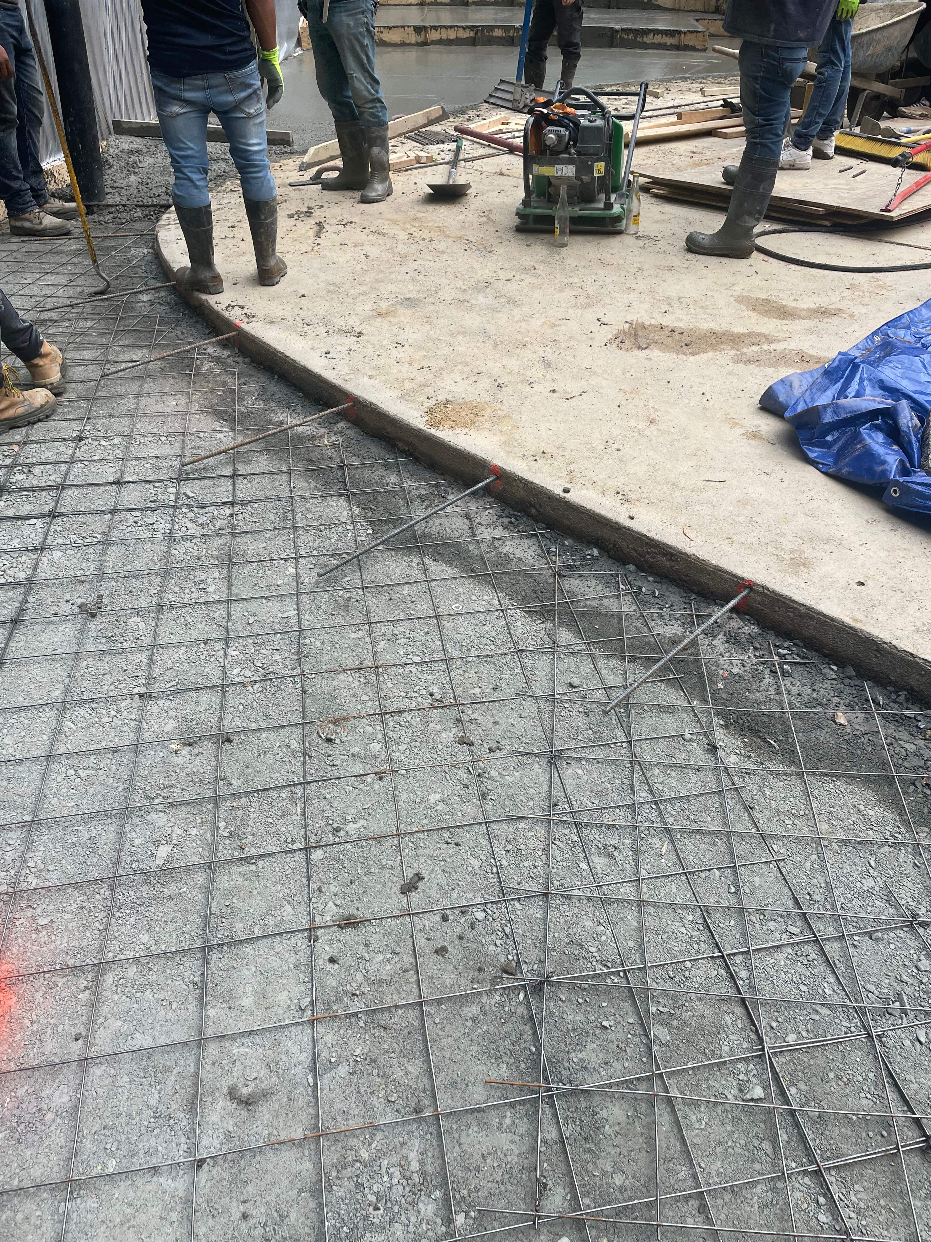 Pool Surround remodel with retaining walls, new waterfall and water slide by Fairfax Contractors, LLC