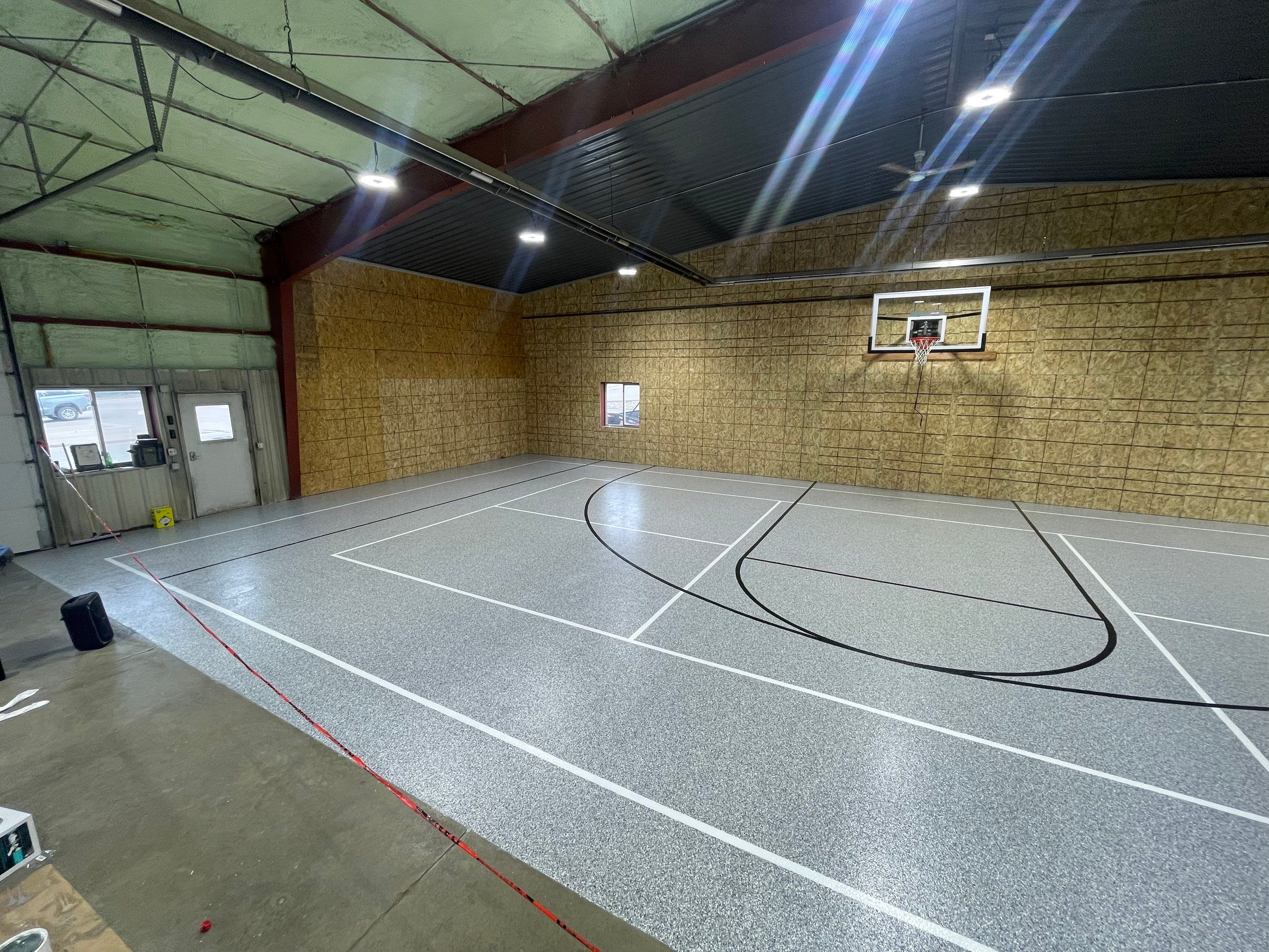 Custom Polyurea Shop Floor with Basketball Court Lines in Rock Valley by Select Painting, Coatings & Garage Cabinets