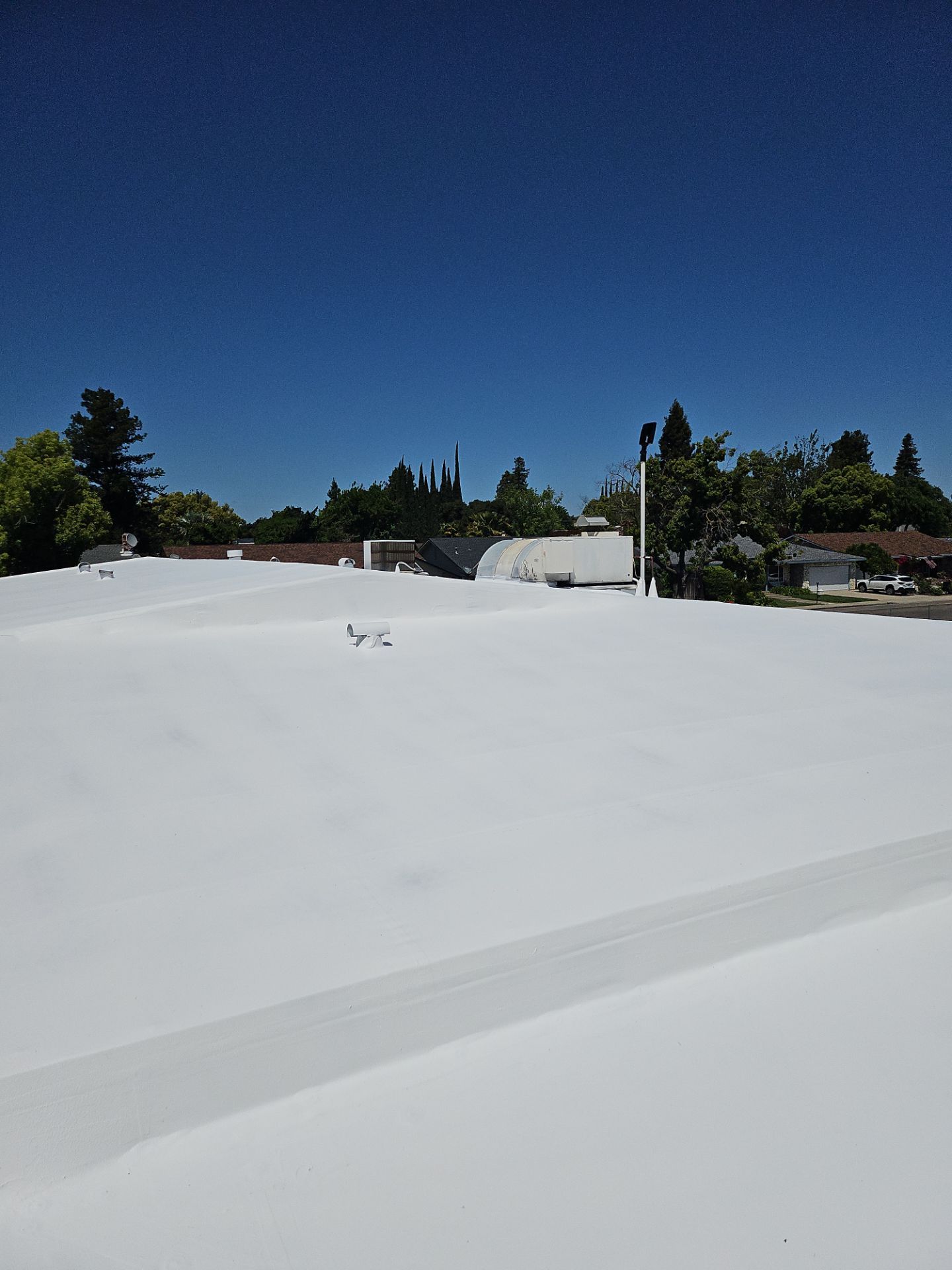 Single-ply restoration system using Benchmark/PUMA XL coatings over TPO single-ply roofing by Straight Edge Roofing Inc