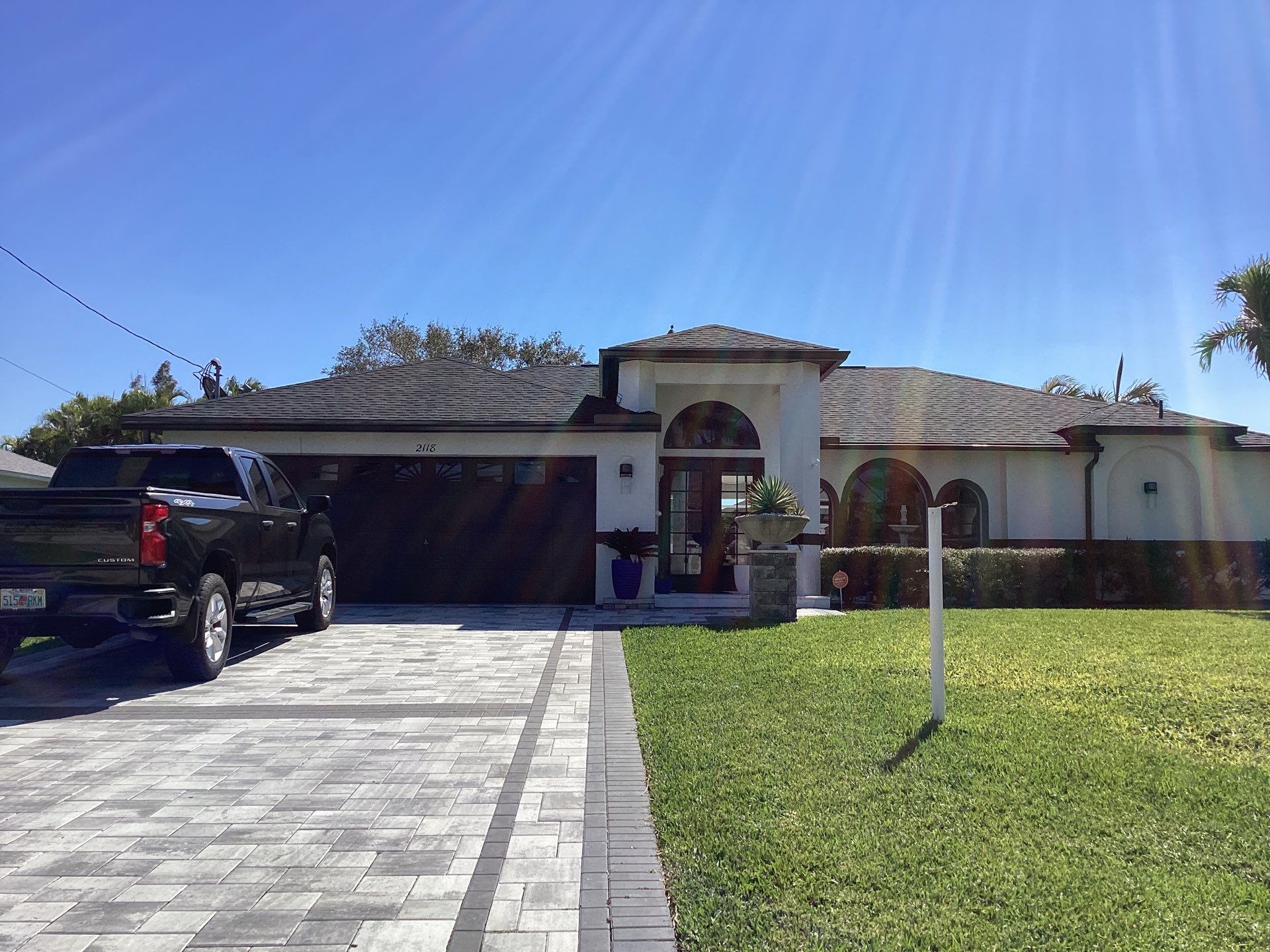 Brown Gutter + White and Brown Downspouts in Cape Coral FL by Gutter Professors
