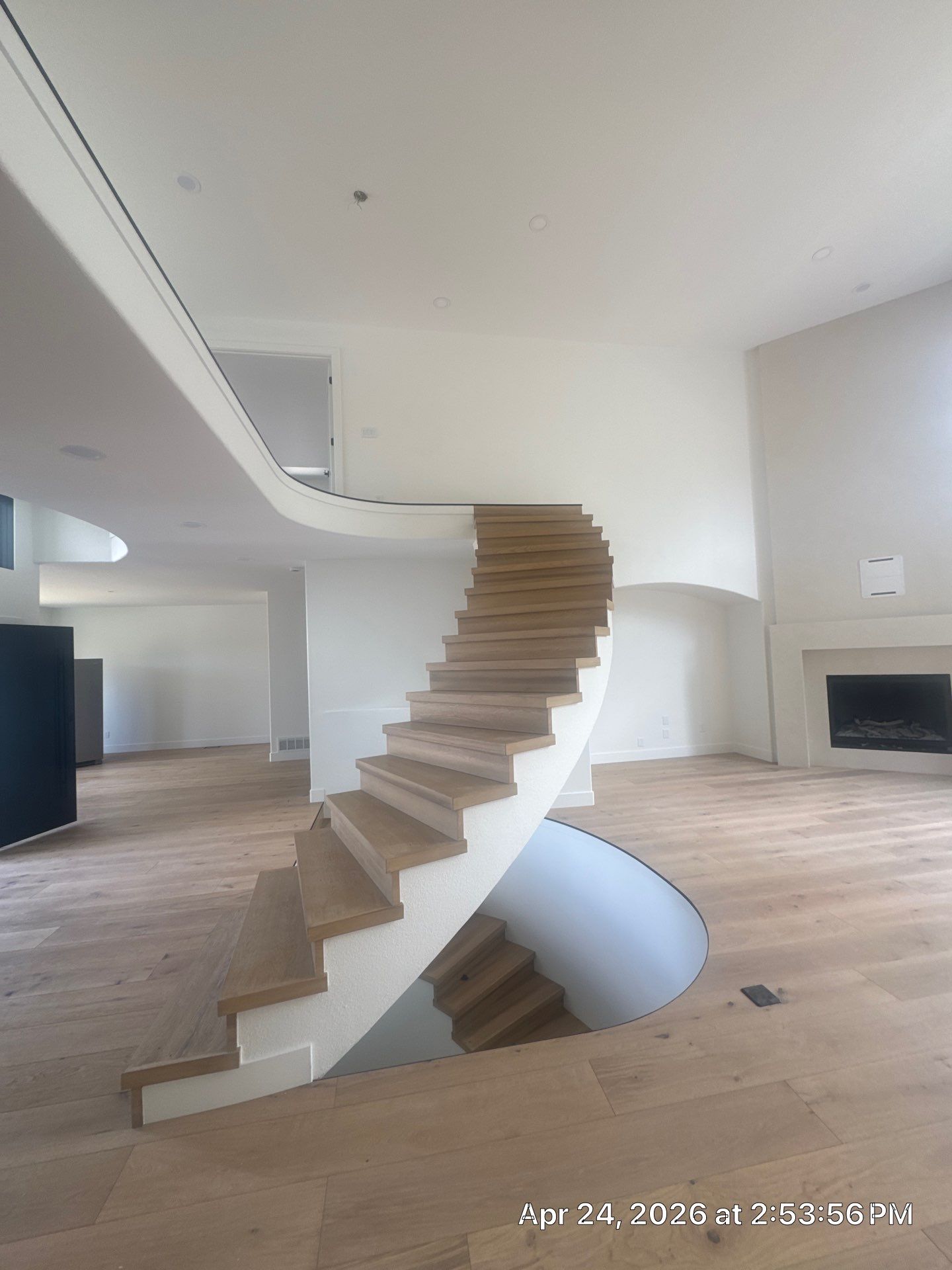 Curved Oak Staircase and Custom Metal Railing Installation in Lone Tree by LP Construction Services