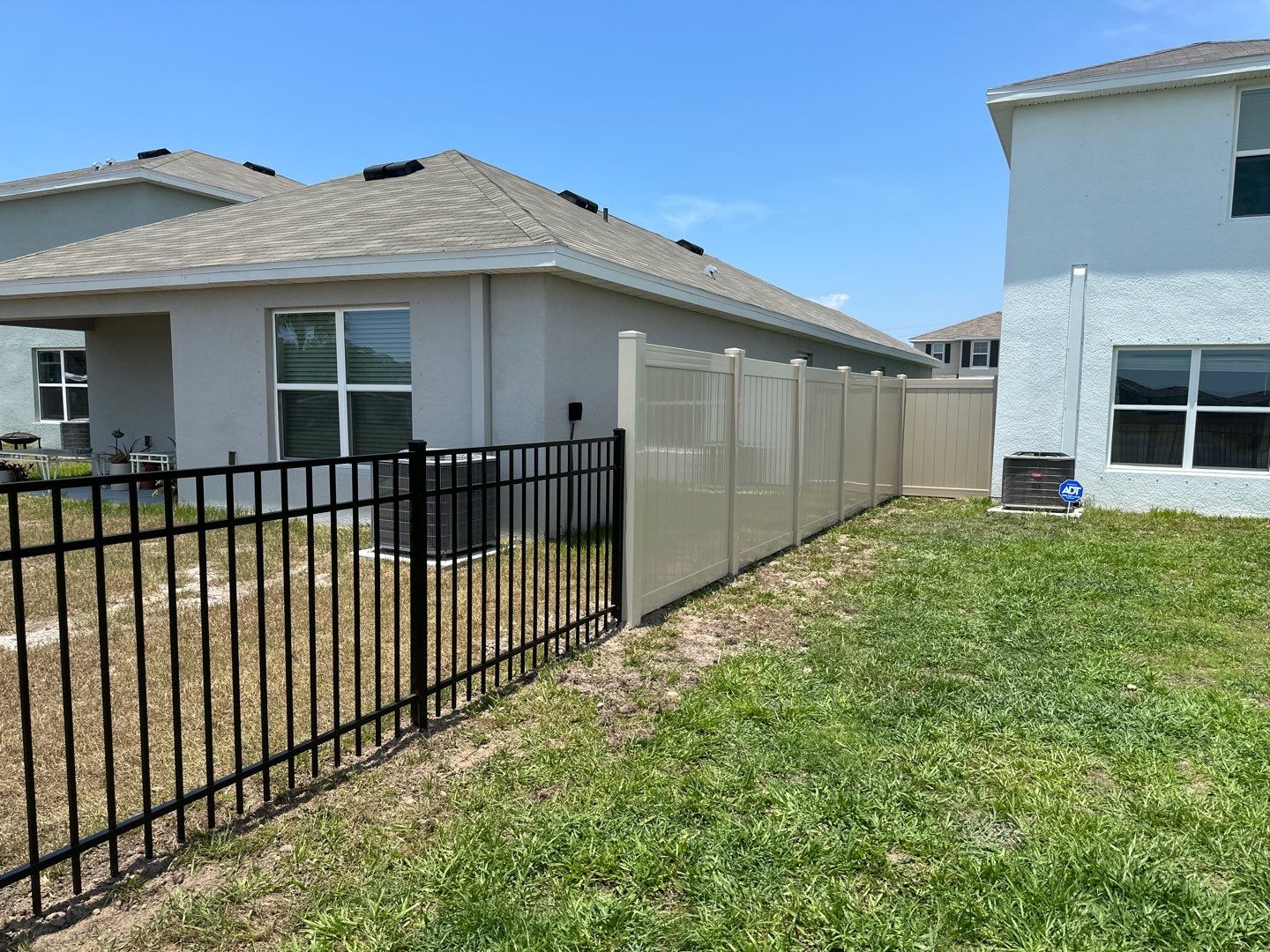 Aluminum Fence Installation using Black 3 Rail Aluminum Fence and Tan Vinyl Privacy Fence by Asap fence and gates, LLC