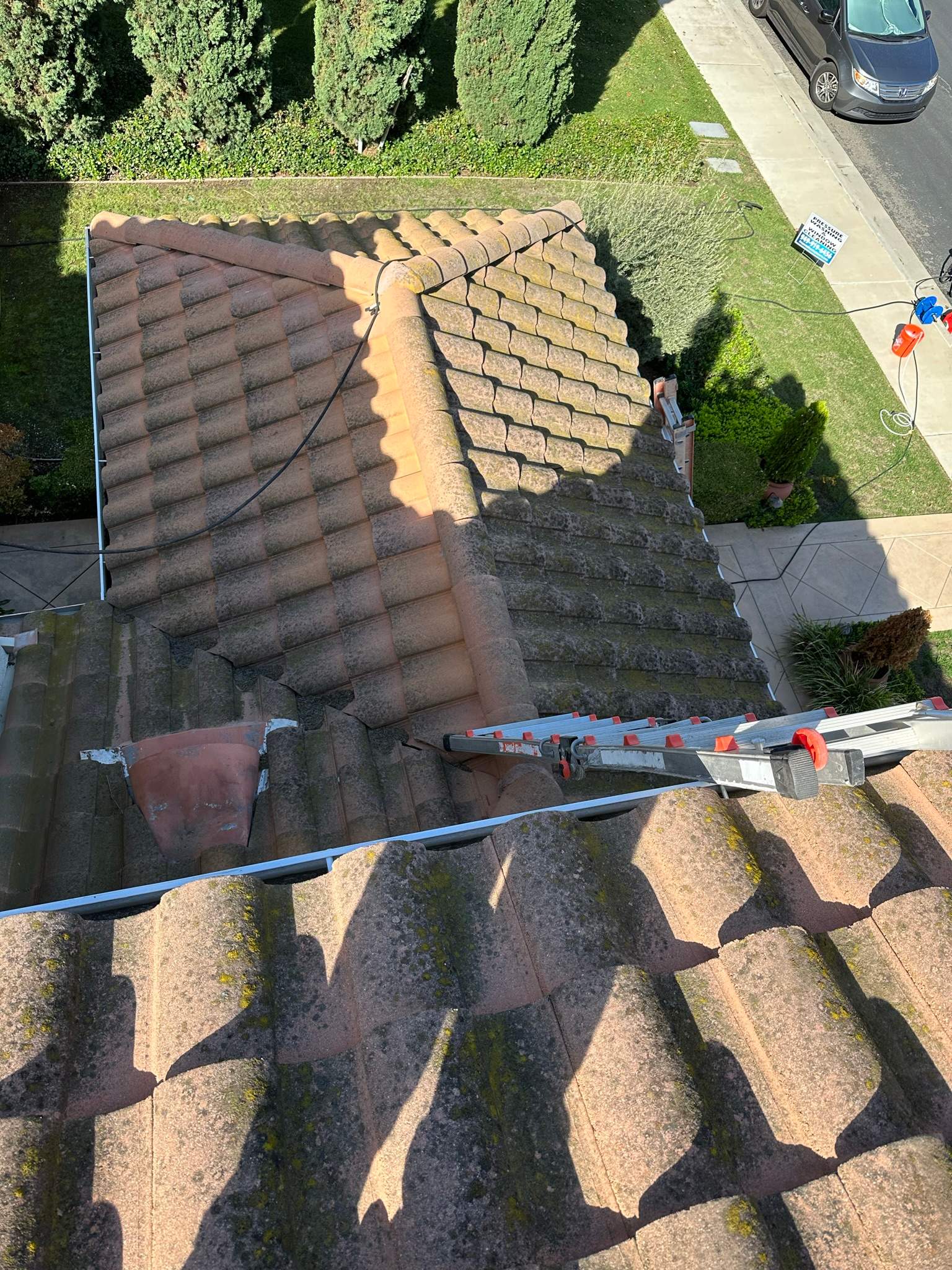 Roof wash on this dirty roof covered in algae by Property Cleaning Experts, LLC