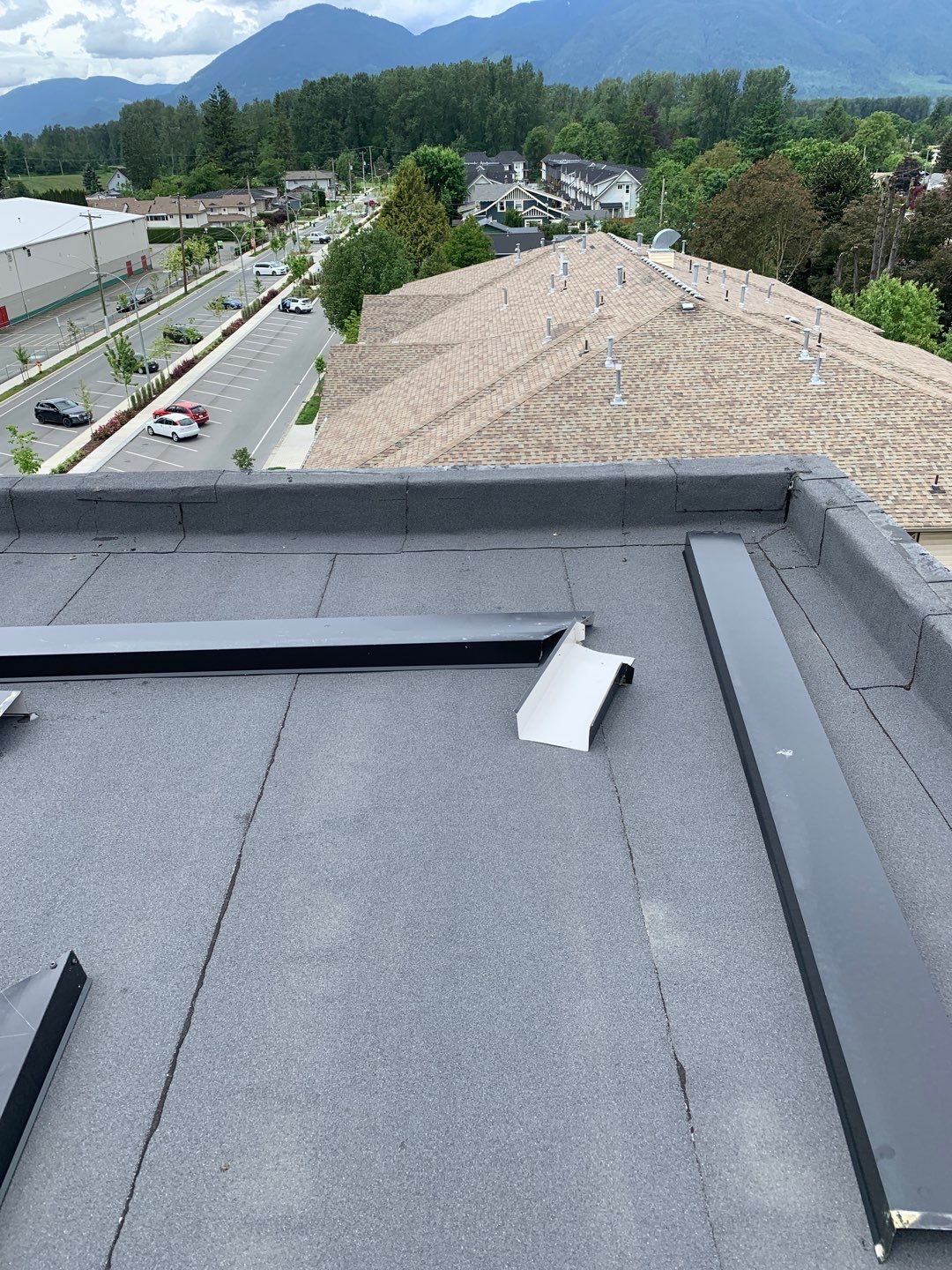 Large apartment with sbs, shingles and prolok metal  by Top Notch Roofing Inc