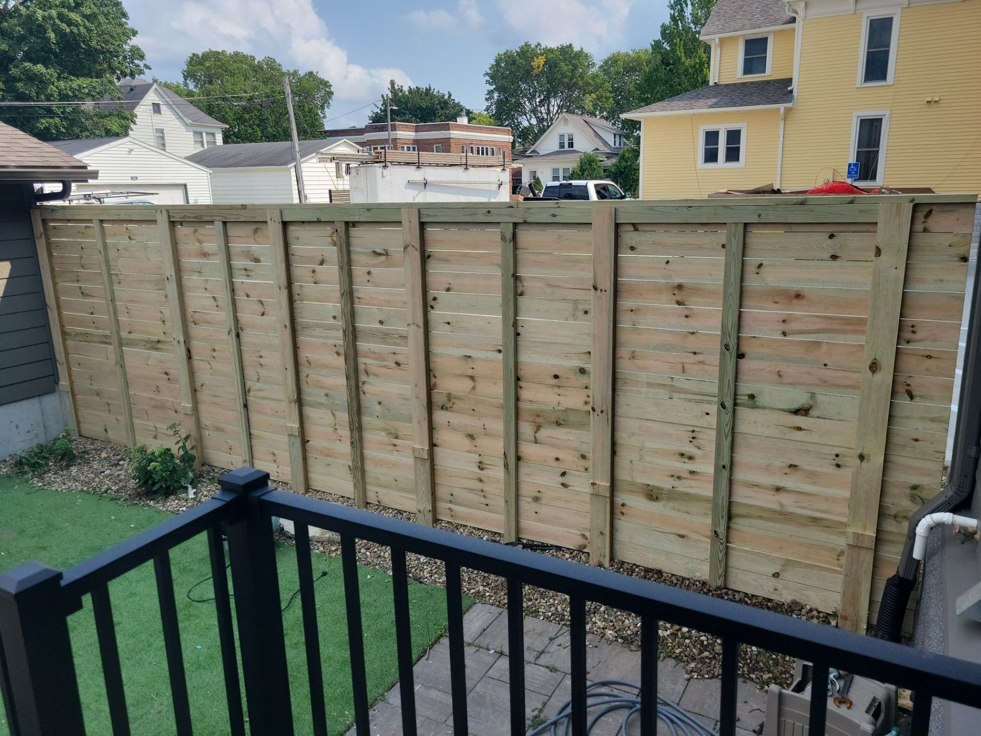 Modern Horizontal Slat Wood Privacy Fence Installation in Cedar Falls by Perfect Picket Fence and Stain