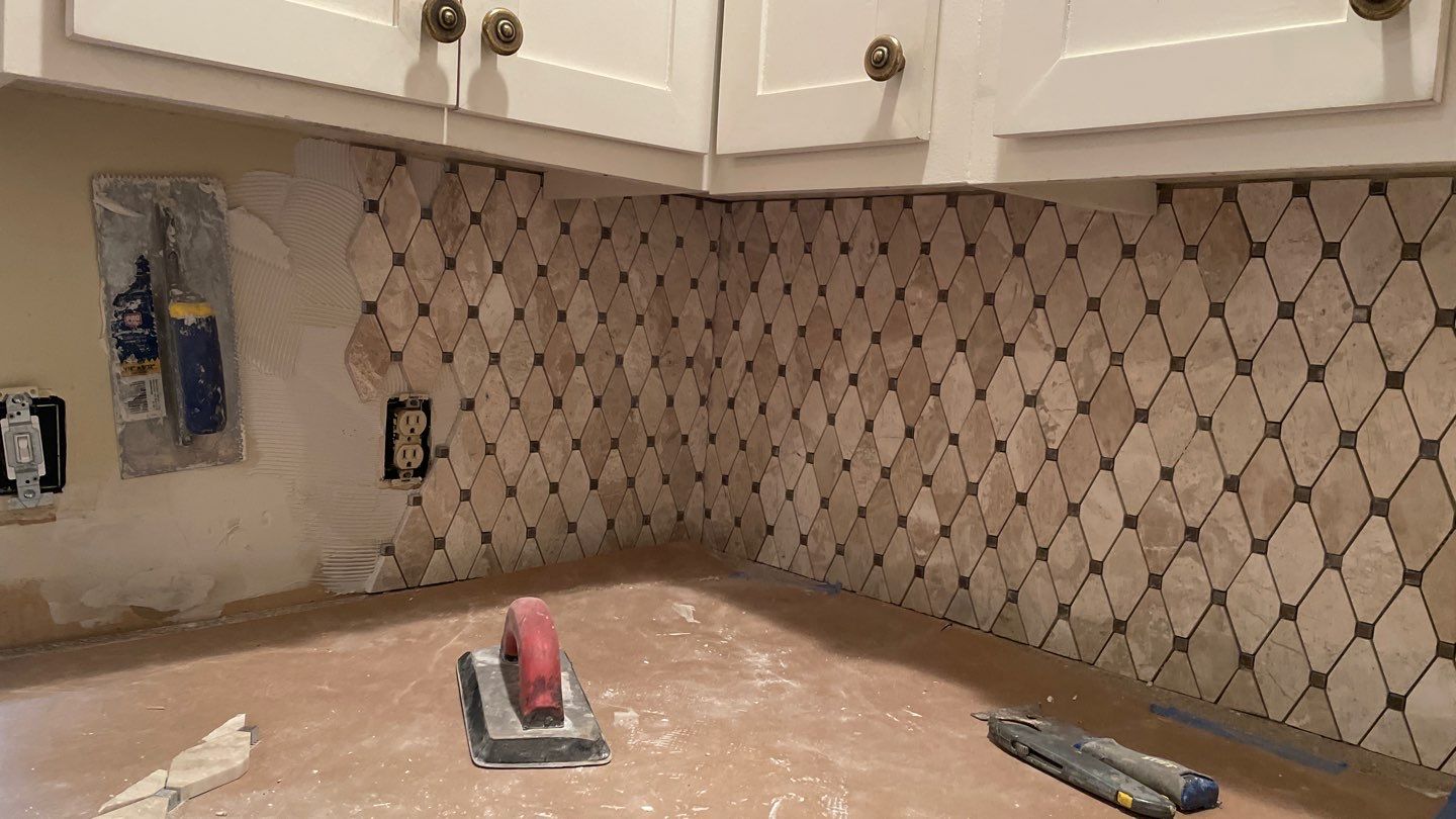 New Backsplash to Compliment the Countertops by Footprints Floors of Coastal Carolina