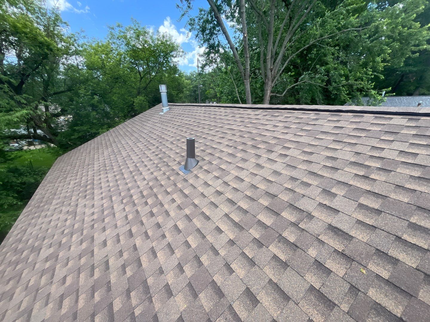 Installing new Roof and Gutter Protection after Hail Damage by Acme Exteriors