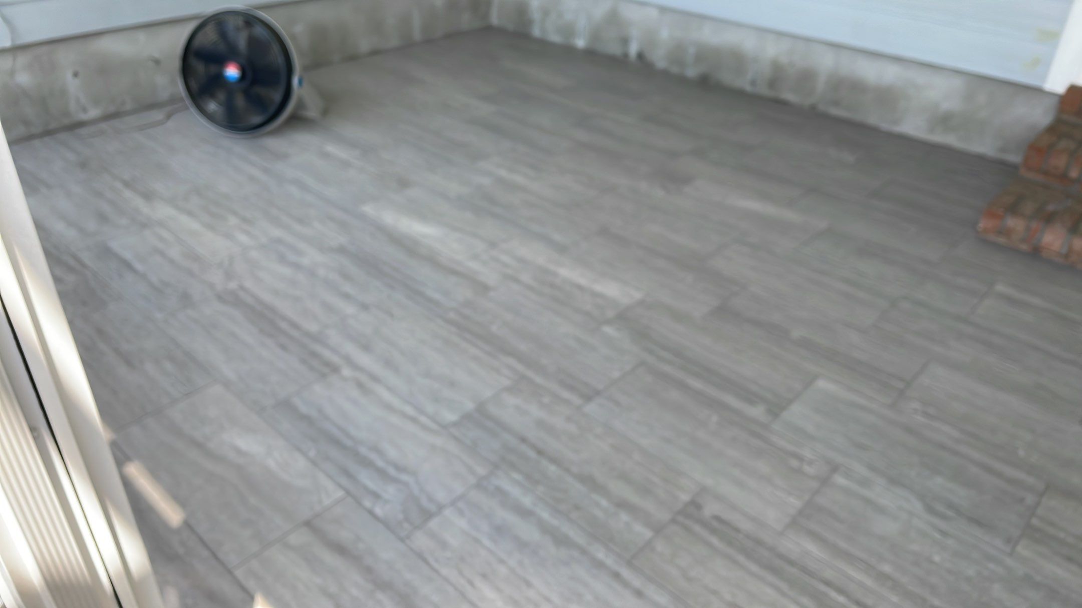 Sunroom using 12x24 tiles by Footprints Floors of Coastal Carolina