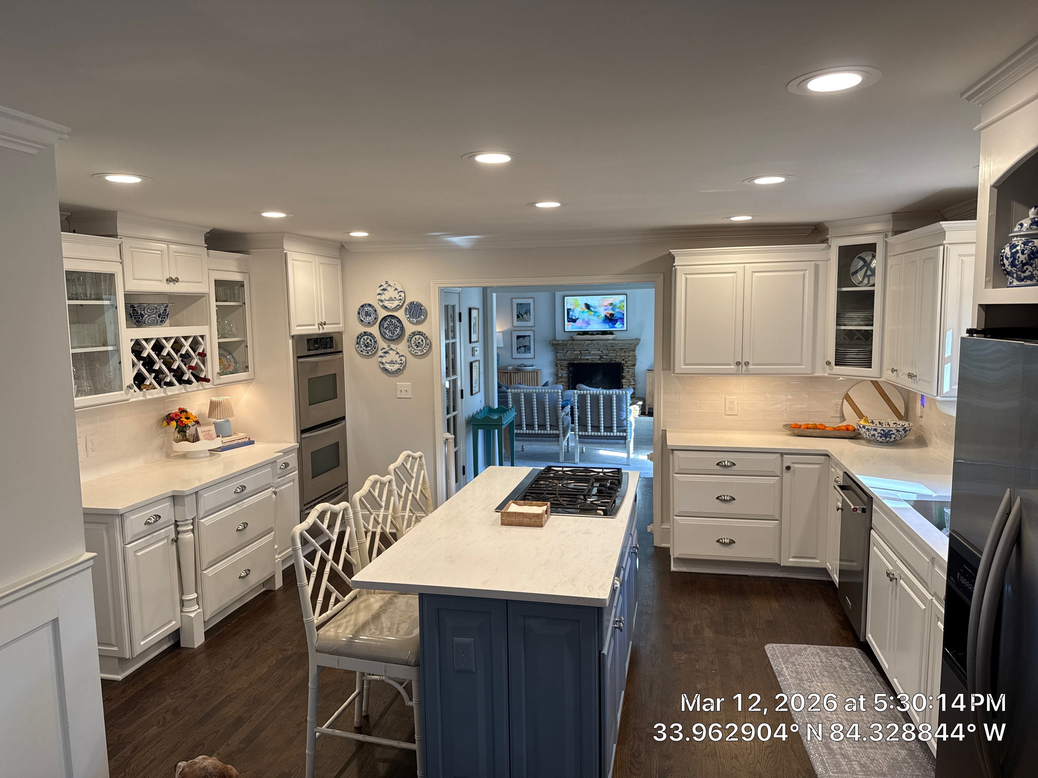 Kitchen Remodel in Dunwoody Featuring White Cabinetry and Blue Island by Heart & Home Kitchen & Bath Remodeling LLC