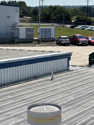 Corrugated metal roof with vents and building exterior