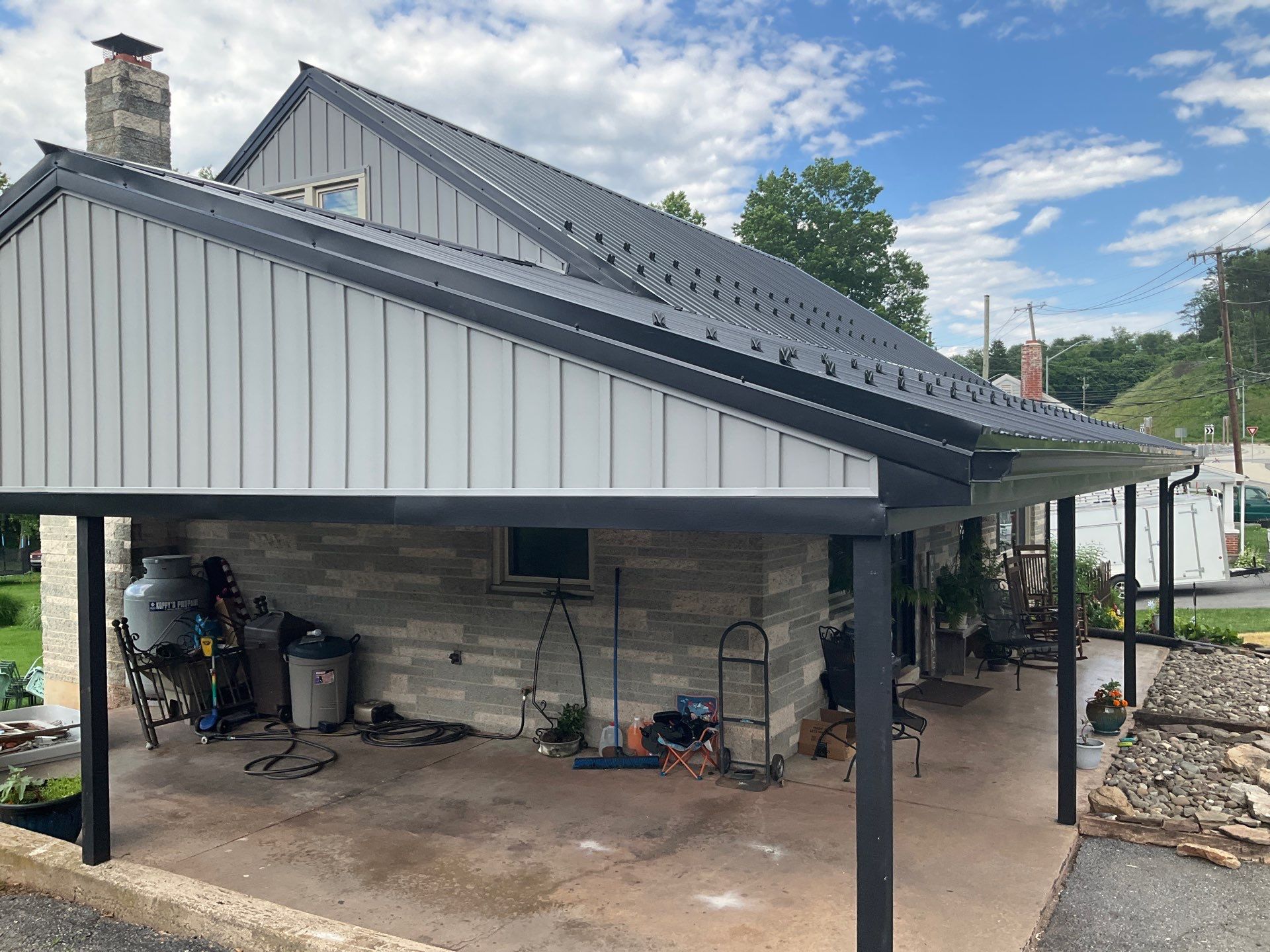 Metal Roofing, Board & Batten Siding, and Entry Door Transformation by Esh Builders