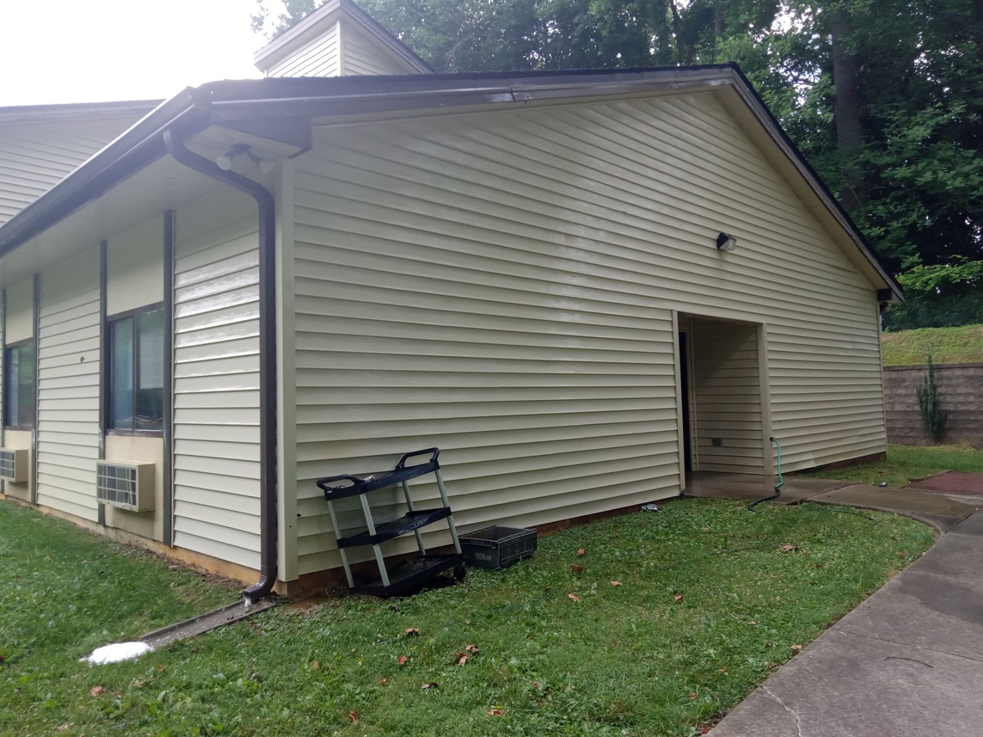 pressure washing exterior siding and gutters to remove dirt algae mold