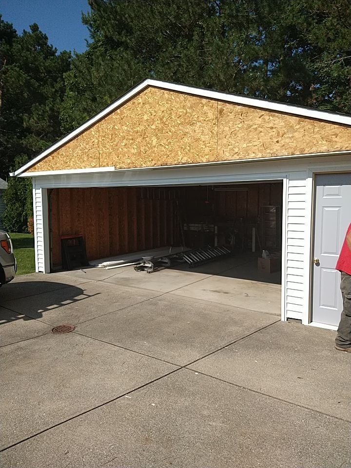 Siding Installation using Norandex woodsman dl-5 white woodgrain vinyl by Absolute Roofing and Construction