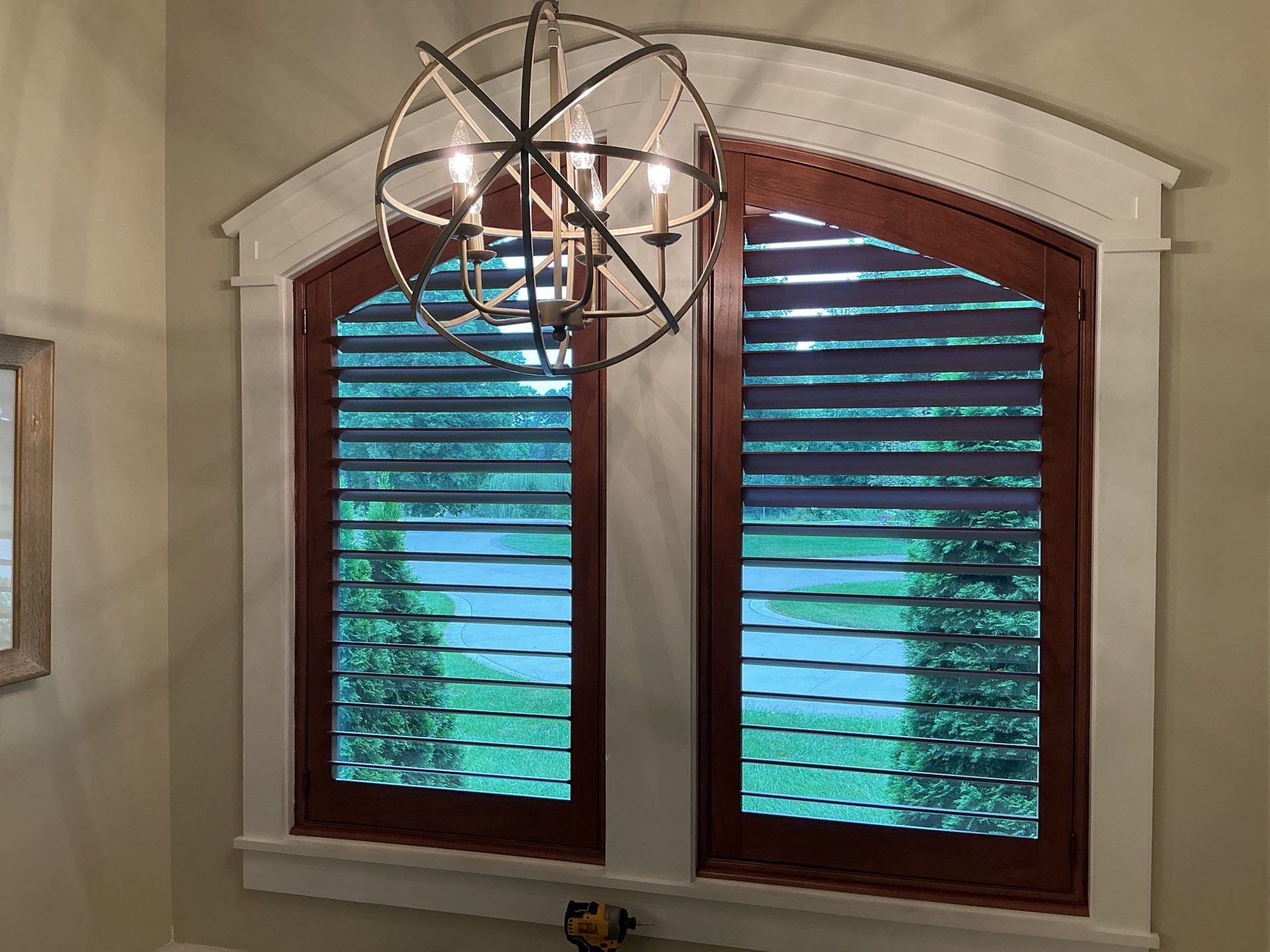 Stained Wood Plantation Shutter Upgrade for Arched Windows in St Joseph by tracy.hickman@budgetblinds.com