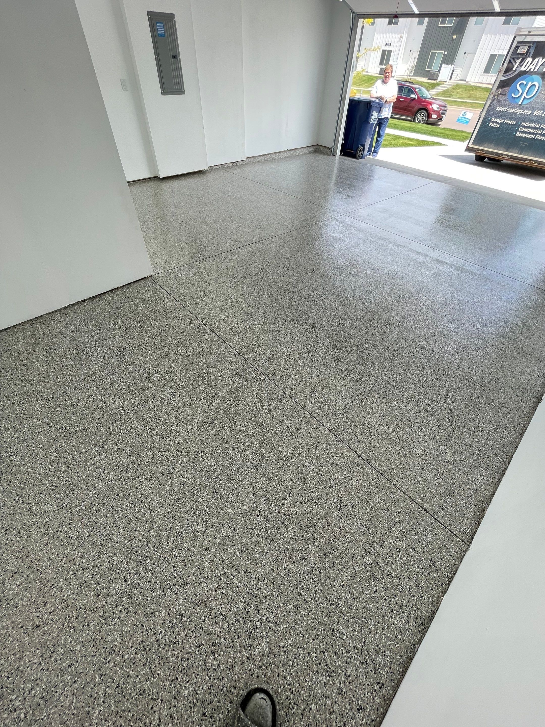 Sioux Falls Garage Floor Transformation with Cabin Fever Decorative Chips by Select Painting, Coatings & Garage Cabinets
