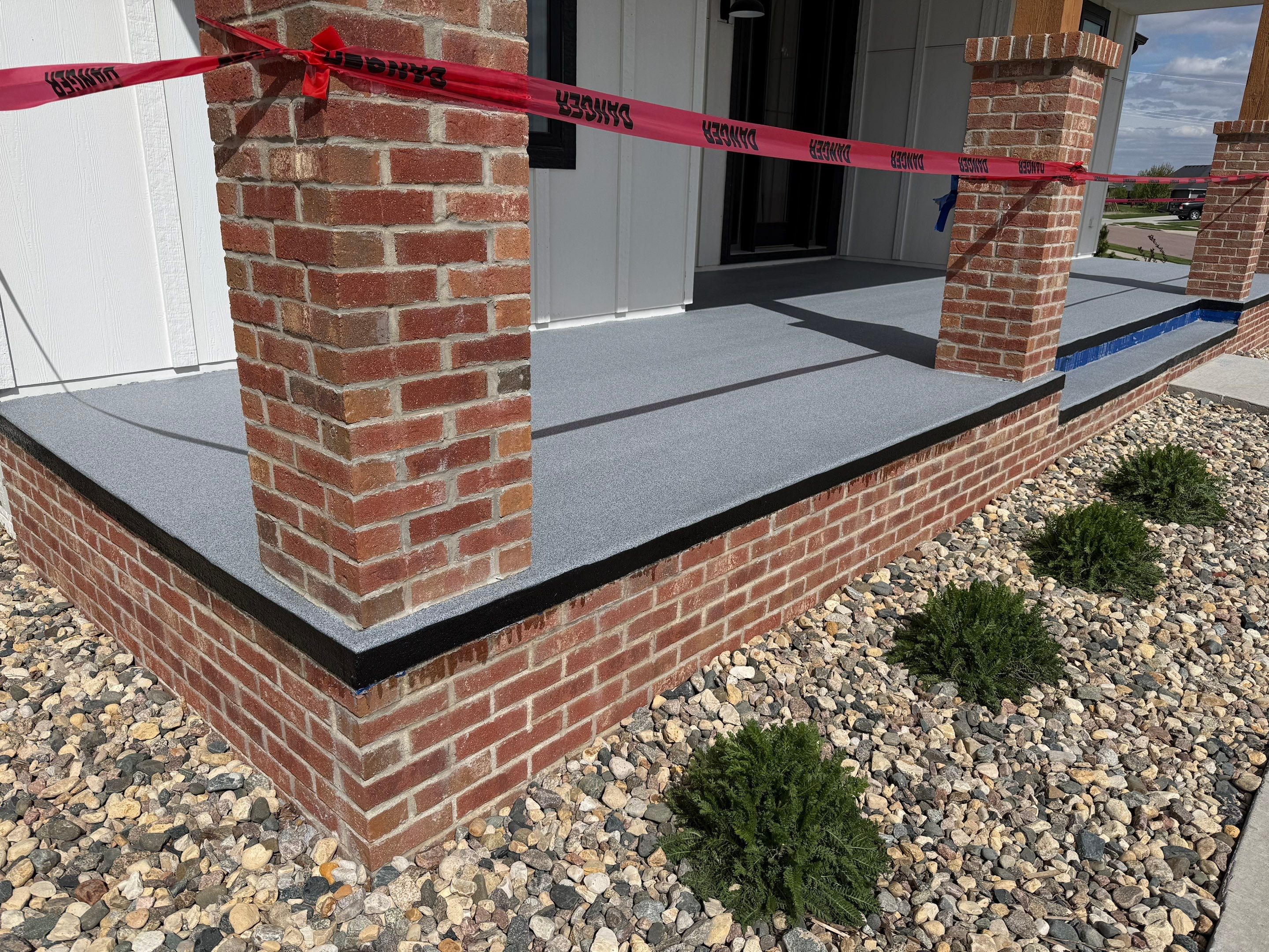 Grey Speckled Concrete Porch Coating for Sioux Falls Home by Select Painting, Coatings & Garage Cabinets