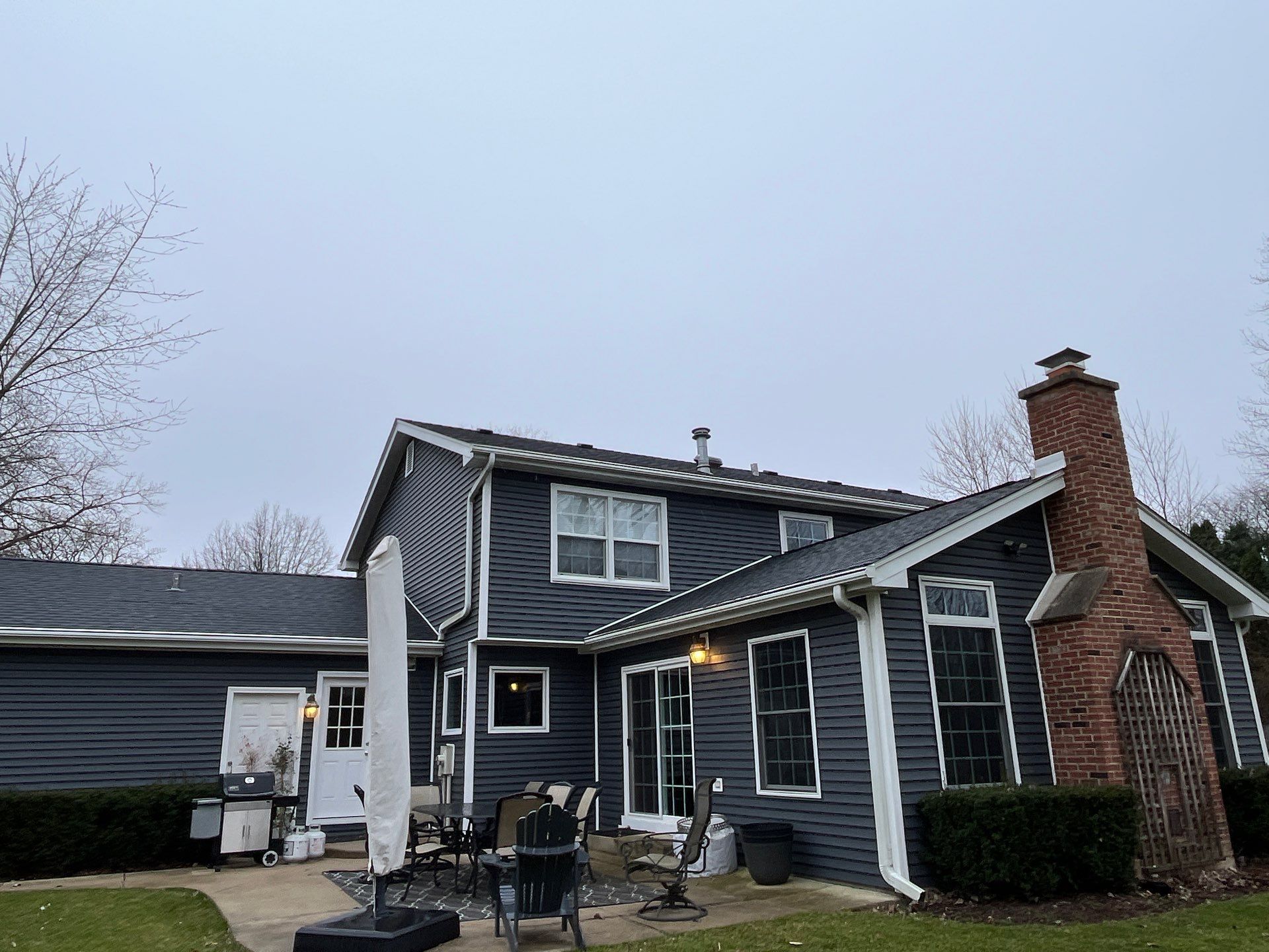 Asphalt Roof Replacement with Aluminum Gutter Installment by Custom Installations
