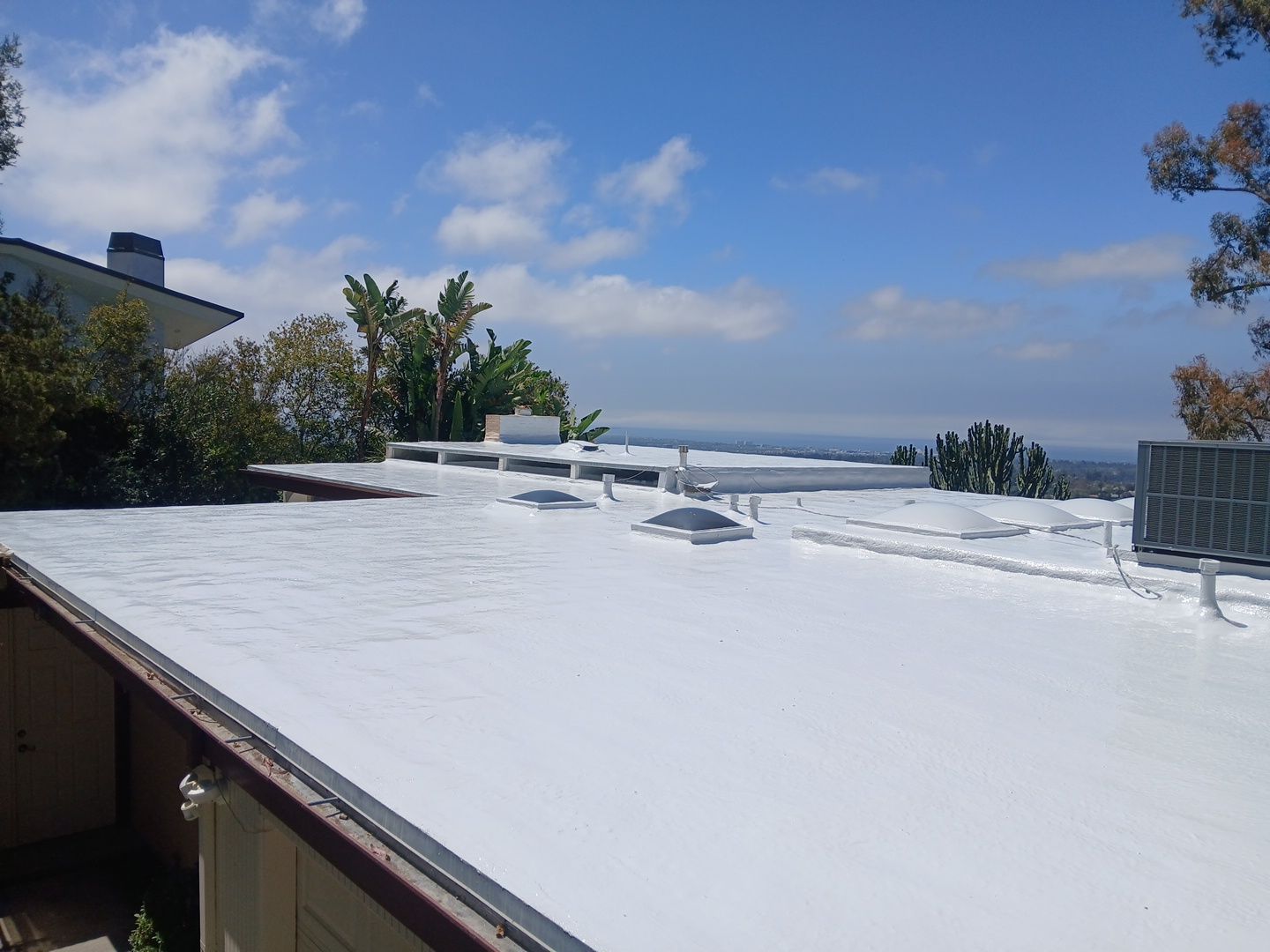 Residential Flat Roof Restoration with Silicone Coating in Brentwood by Hull Brothers Roofing