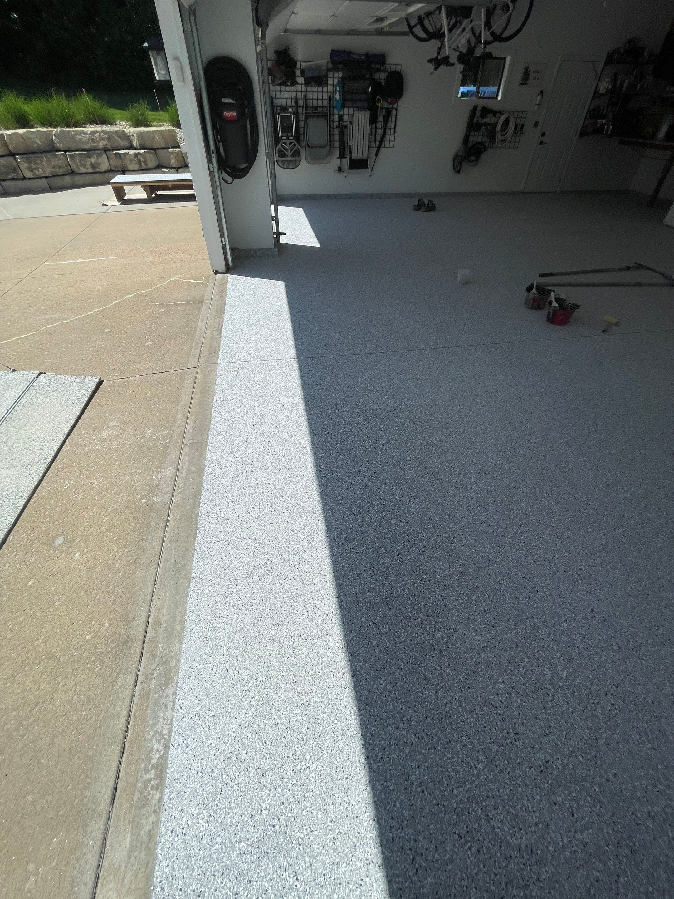 Feather Grey Garage Floor Coating Installation in Sioux Falls by Select Painting, Coatings & Garage Cabinets