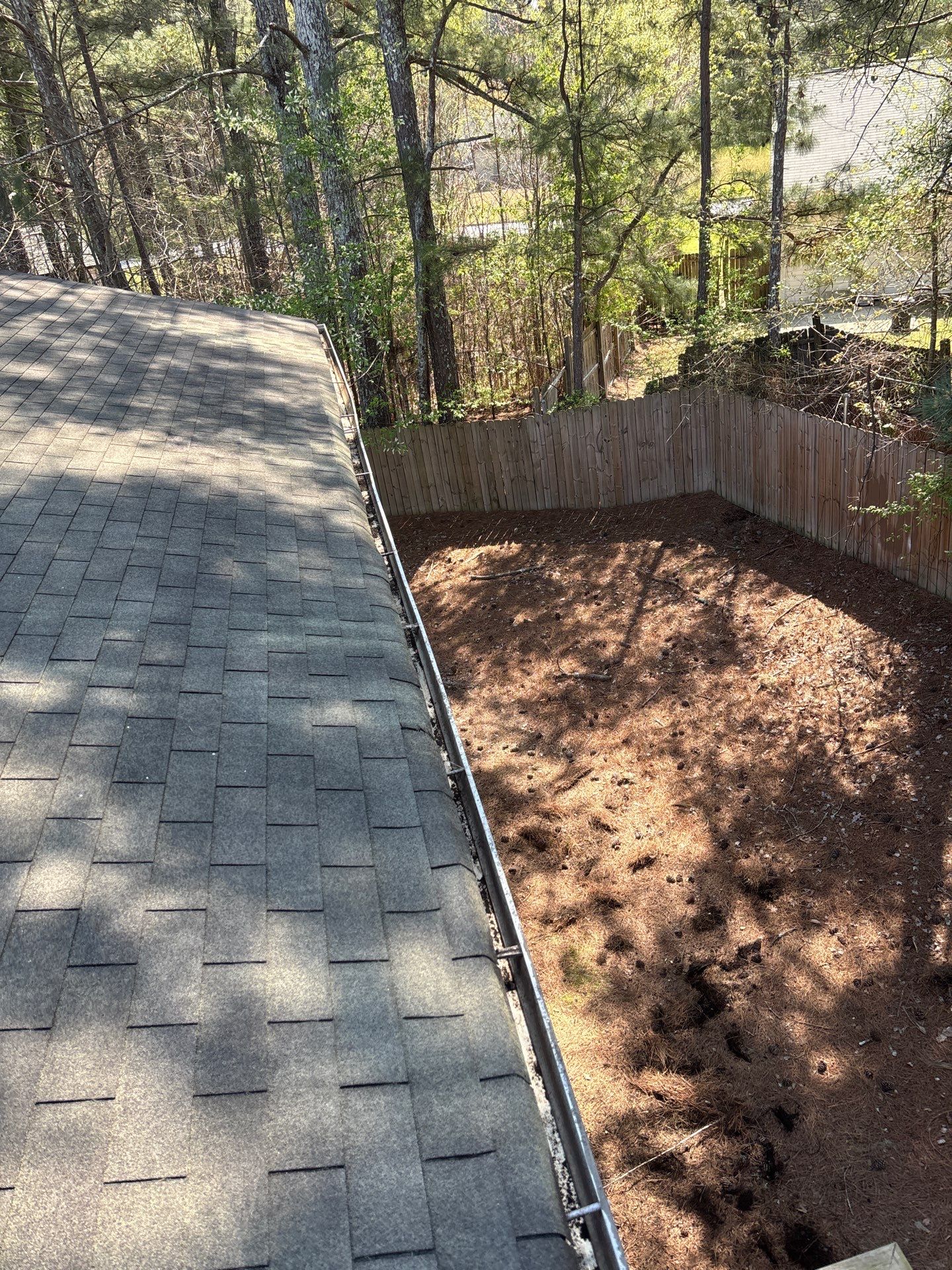 HOA gutter cleaning in Peachtree City, after  photo showing full gutters.