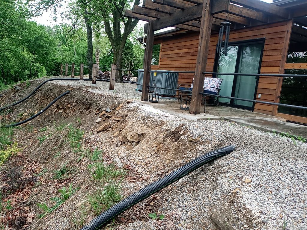 Supporting back of home with backfill at edge of steep creek by LAND ESCAPES LLC