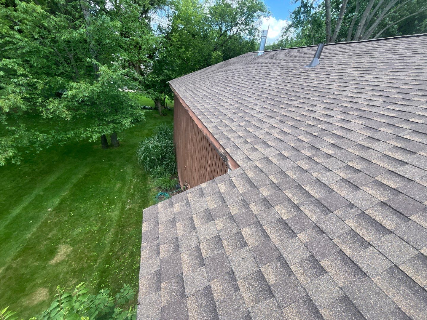 Installing new Roof and Gutter Protection after Hail Damage by Acme Exteriors