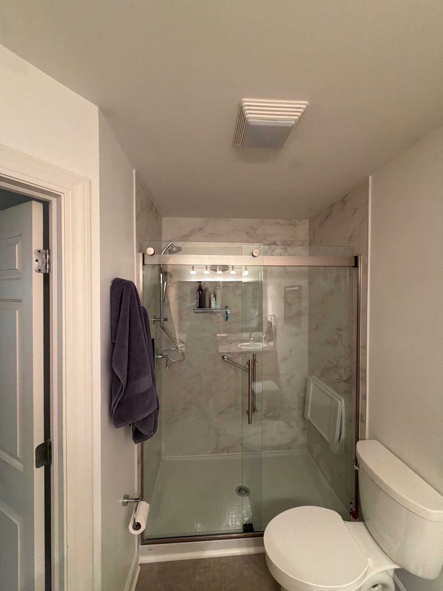 Greenfield Bathroom Remodel Featuring Double Vanity and Marble Tile Shower by OCS Contracting Services