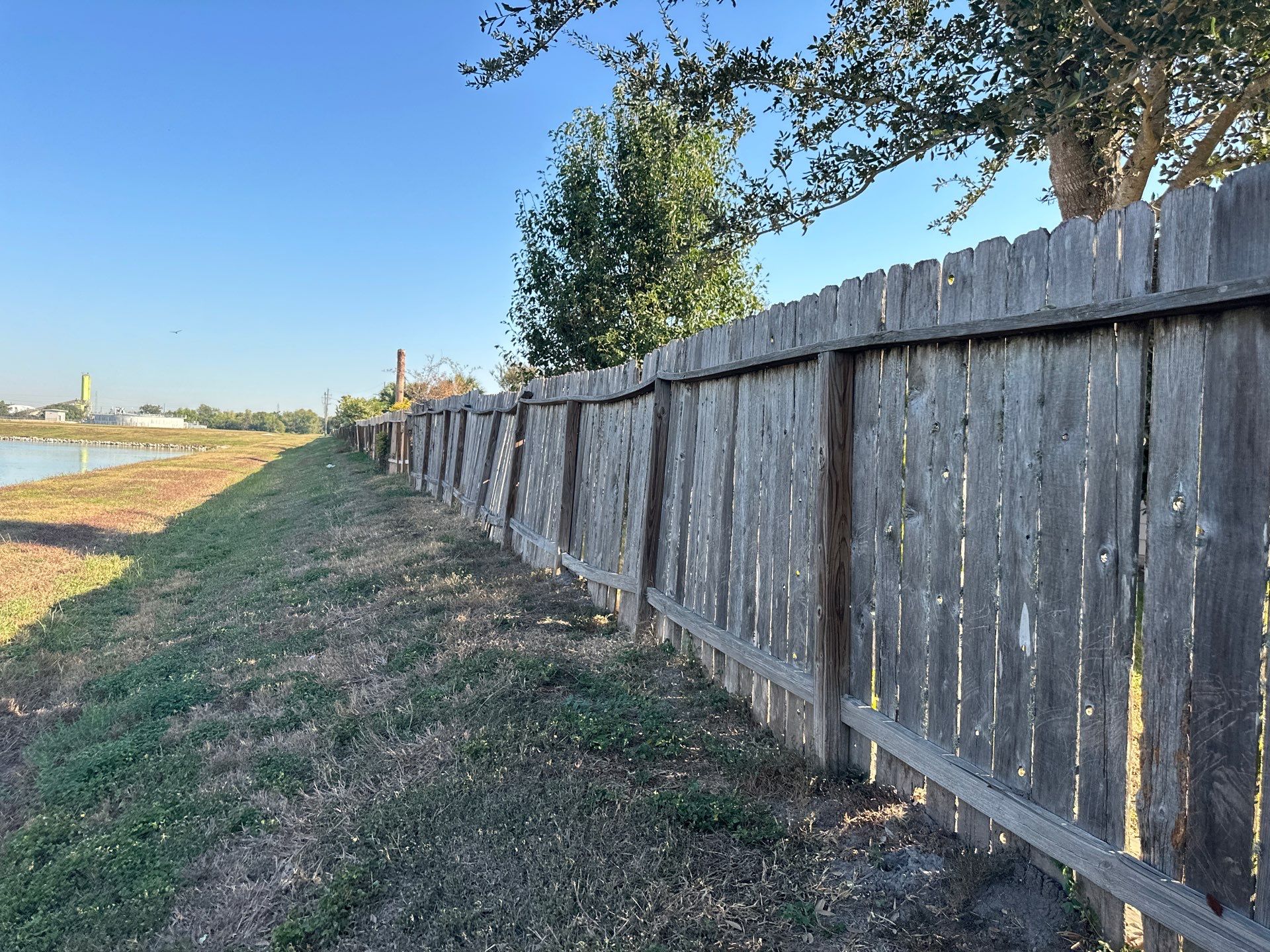 Beautiful Wood fence with metal posts by Tim's Fences