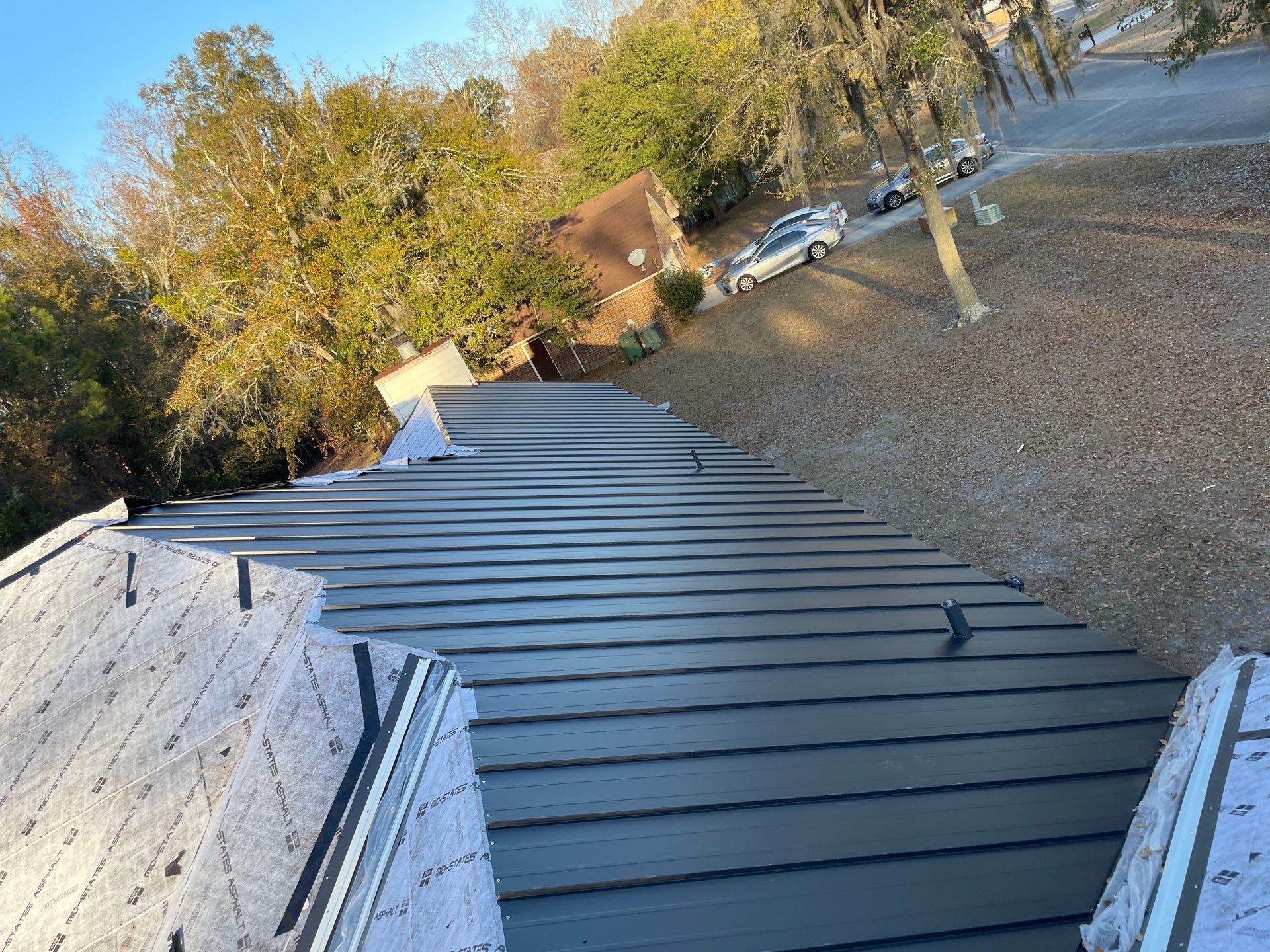 Residential Roofing Installation using Benton 26Ga 1inc Snapcock Metal Roof KYNAR Matte Black by Talya Roofing