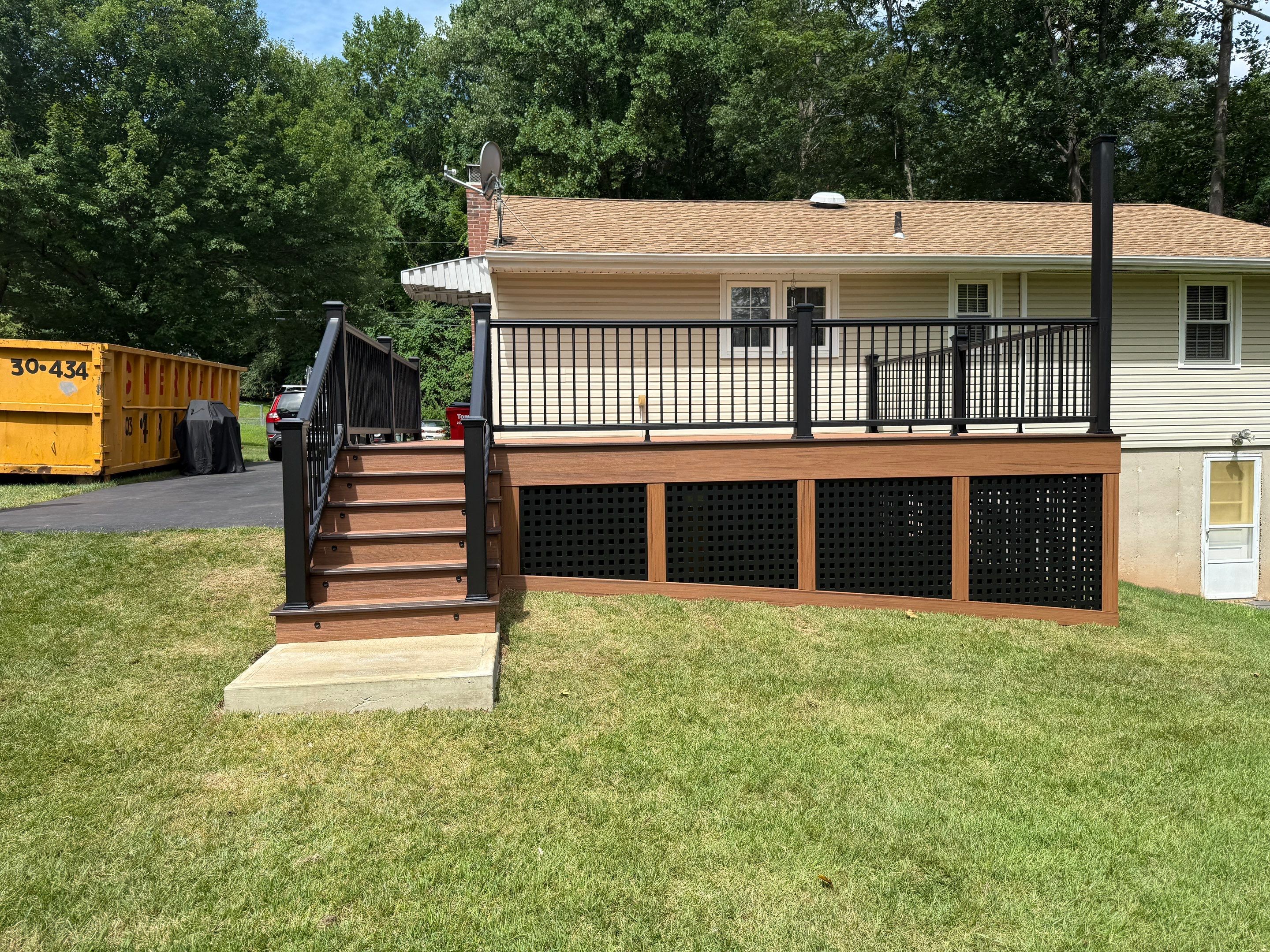 Replacement Deck, Trex Tropical Tiki torch , Matching Fascia. Black Transcend railing and Lattice. by DiGiorgi Roofing and Siding Inc