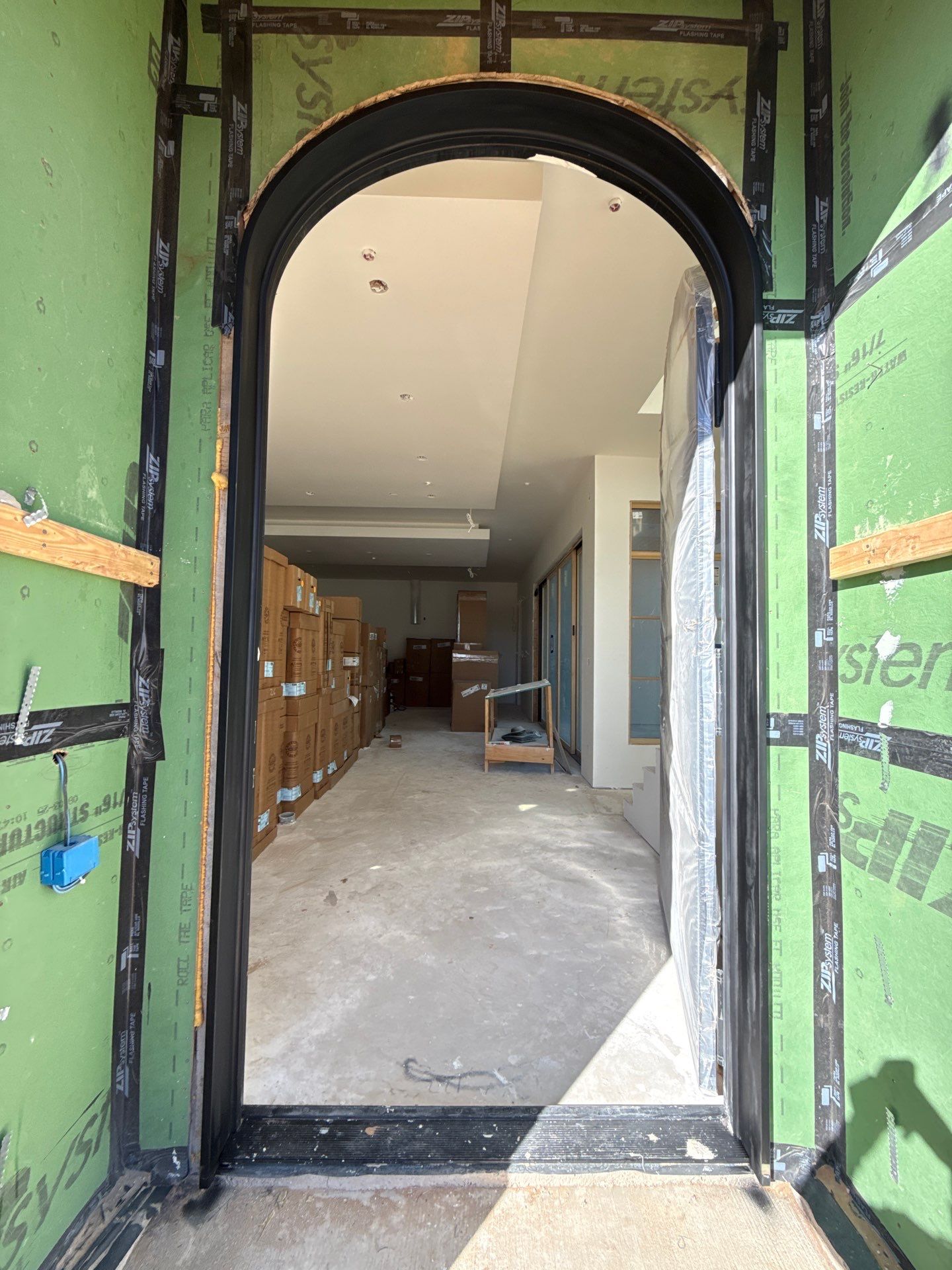 Custom Black Metal Arched Entry Door Installation in Southlake by Solara Custom Living