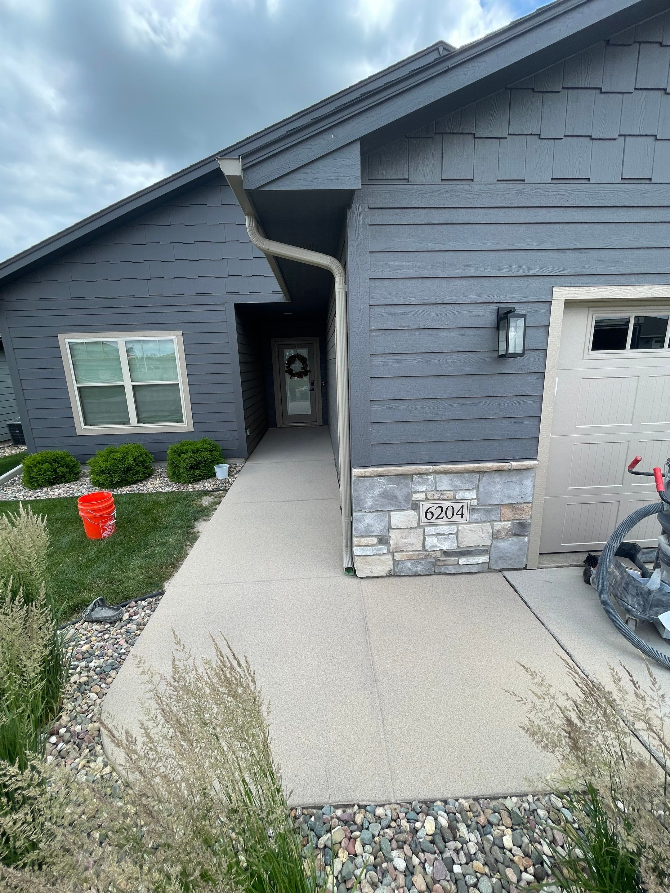 Textured Concrete Patio Coating and Custom Privacy Pergola in Sioux Falls by Select Painting, Coatings & Garage Cabinets