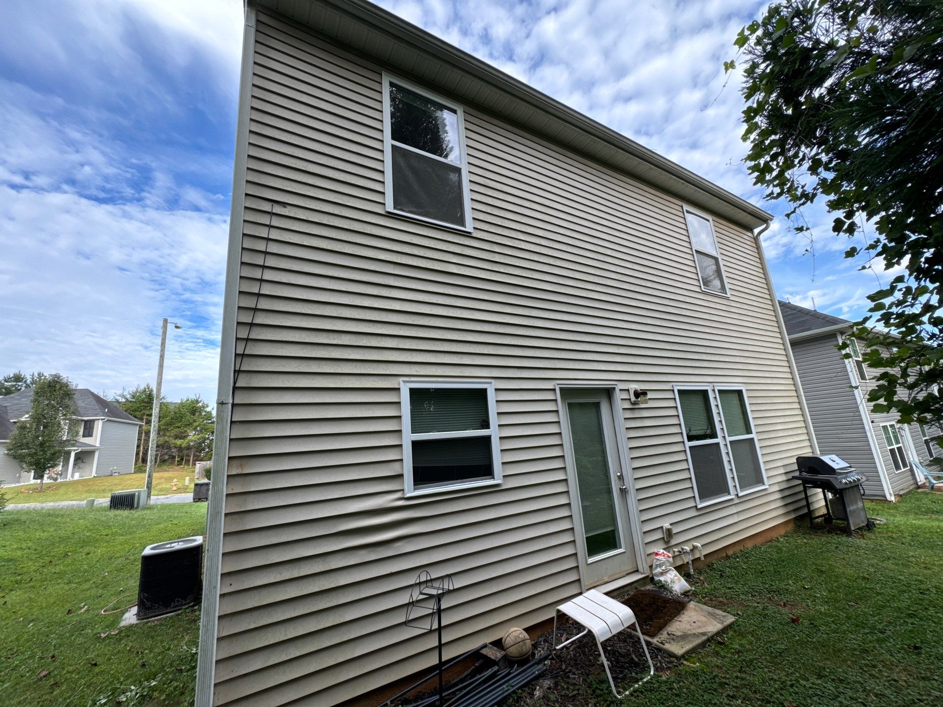 the service being done is cleaning the siding of a residential home to remove dirt and grime buildup