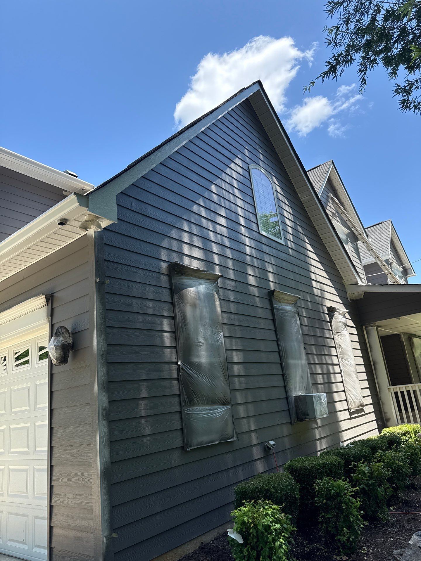 Siding replacement, exterior painting, and front door staining. by GonzalezPainters & Contractors Inc