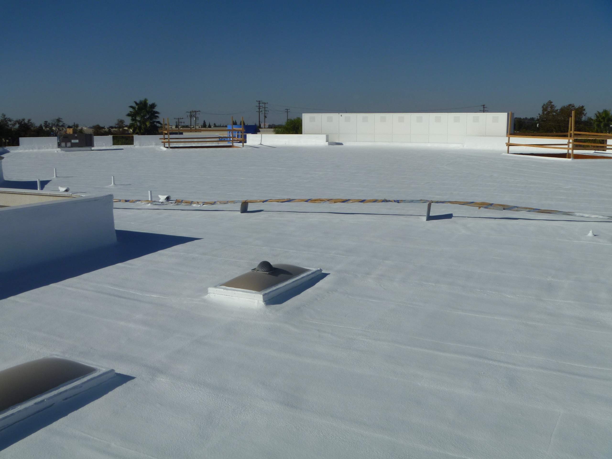 Commercial Roofing Installation using Spray foam and Conklin Benchmark/PUMA XL 18 yr warranty coatings by Straight Edge Roofing Inc